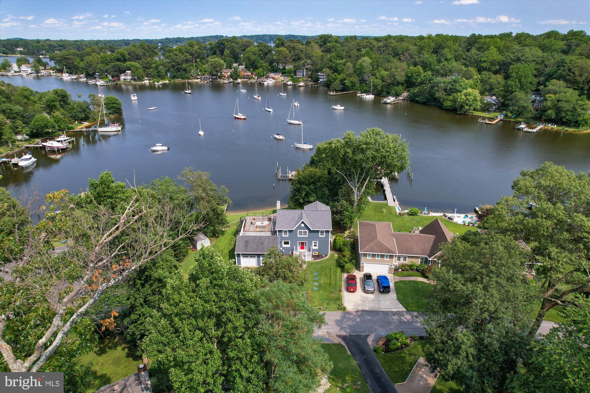 Discover the epitome of waterfront living in this captivating home nestled along the shores of Valentine Creek. Boasting a deep-water pier with slips and a boat lift, this property offers not just a home, but a lifestyle. Ascend a few stairs to your private beach, a serene retreat just steps from your door. 

This meticulously designed residence features a 2-car garage, 3 bedrooms, and 3 full bathrooms. The upper level is a sanctuary, exclusively dedicated to the owner's suite. Revel in luxury with an extra-large bathroom, complete with a soaking tub, a custom walk-in closet, and the convenience of an adjacent laundry room. The living room on this level provides a panoramic view of Valentine Creek, creating a tranquil escape within your own home. 

On the main level, two bedrooms, a full bathroom, and a spacious living room complement the heart of the home—a chef's kitchen adorned with red Birch cabinets, granite countertops, and tiger wood floors. A sitting area and dining space overlook the picturesque Valentine Creek, making every meal a scenic experience. 

The fully finished walk-out lower level is a haven of entertainment, offering a recreation room, additional storage, and another full bathroom. Step outside to enjoy the waterfront ambiance or ascend to the rooftop deck accessible from the upper-level living room—a perfect vantage point for sunset views. 

Crafted for comfort and durability, the hardy plank siding ensures not only a sturdy exterior but also contributes to sound reduction. With approximately 3,800 sq. ft. of finished living space, this home has been completely updated to meet the highest standards of modern luxury. 

Located in the coveted neighborhood of Arden on the Severn, residents enjoy exclusive access to five beaches, three boat ramps, and a vibrant community association hosting events throughout the year. Embrace the coastal lifestyle, where every day feels like a vacation in this waterfront haven.