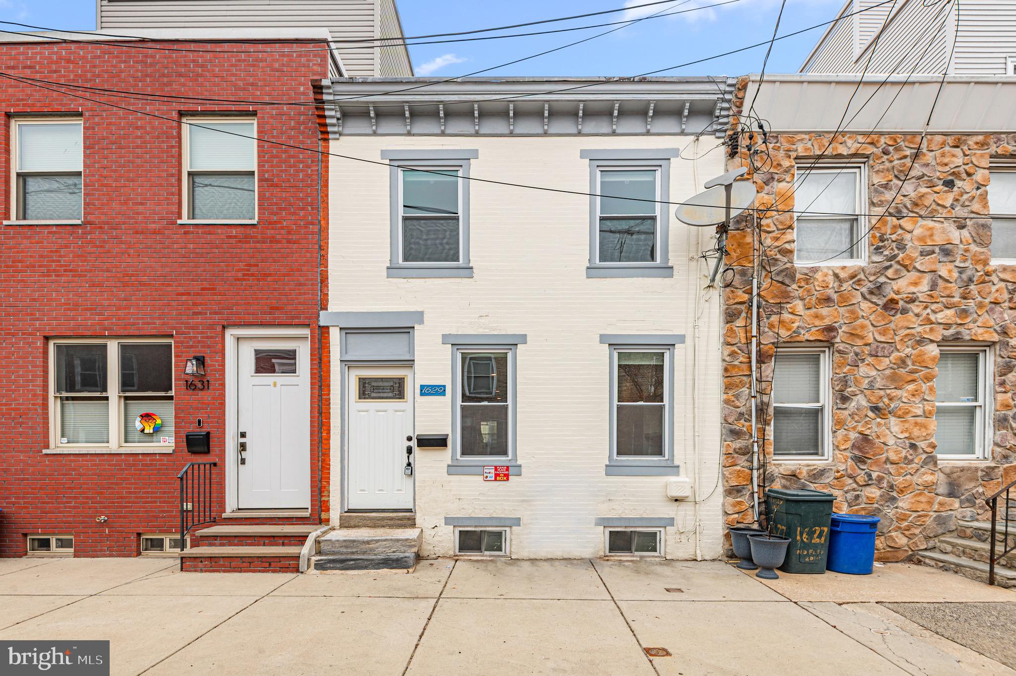 Welcome to 1629 Annin Street, a charming brick home in the heart of South Philadelphia offering three well-sized bedrooms, two luxurious full bathrooms, and a convenient main-level powder room. This updated home features hardwood floors throughout, recessed lighting, a modern kitchen with marble countertops and Whirlpool appliances, a Samsung washer and dryer, a recently installed Evcon heater and central air system (within the last 5 years), a semi-finished basement, and updated windows. Enjoy the private, generously sized backyard perfect for relaxing, gardening, or entertaining. Ideally located just one block from Washington Avenue and about a half mile to Broad Street, this home provides easy access to Center City, transit, Rittenhouse Square, South Street, and a wide array of nearby restaurants, cafes, shopping,  parks, and nightlife.
