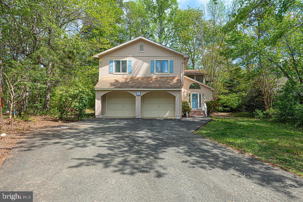 Major Price Adjustment ! Nestled on a quiet cul-de-sac in the desirable community of Ocean Pines, this custom-built 4-bedroom, 3 full bath home offers a rare opportunity to enjoy golf course living at its finest. Perfectly positioned along the 4th hole of the prestigious Robert Trent Jones Golf Course, the property showcases sweeping fairway views and a serene setting.Designed with both comfort and functionality in mind, the home features an open floor plan filled with natural light. Expansive windows and sliding glass doors throughout the kitchen, dining area, and great room provide stunning panoramic views from nearly every angle. The great room is anchored by a cozy fireplace, creating a warm and inviting gathering space.The recently renovated kitchen (2020) is a standout, featuring granite countertops, stainless steel appliances, a center island, and soft-close cabinetry, all complemented by durable LVP flooring. Just off the main living area, a spacious three-season room with vinyl tech windows offers the perfect spot to relax year-round, with direct access to the wraparound double decks—ideal for entertaining or simply enjoying the peaceful surroundings.
The flexible floor plan includes a first-floor bedroom and full bath, perfect for guests or convenient single-level living. Upstairs, the primary suite offers a private retreat with its own bath, while two additional bedrooms and another full bath complete the second level.Additional highlights include a 1.5-car garage with workshop space and ample storage, a newly installed hot water heater, and an oversized lot that maximizes both privacy and those beautiful golf course views.Whether you’re searching for a primary residence, a vacation escape, or a beach-area investment property, this home delivers exceptional versatility and lifestyle appeal—all just a short drive from the shores of Ocean City. Home is being sold AS-IS as a matter of convenience for sellers.