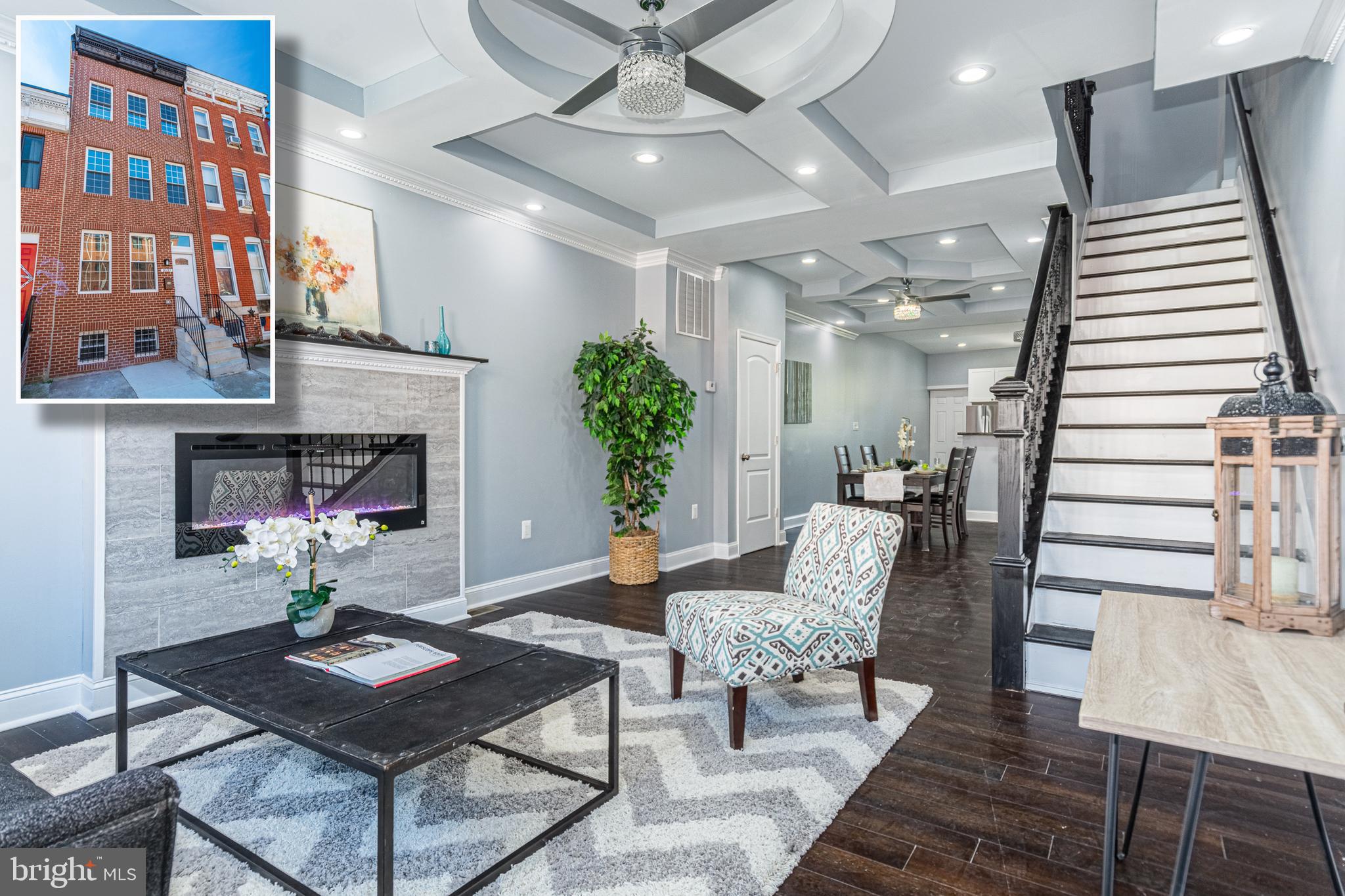 CONTEMPORARARY ELEGANCE RADIATES THROUGHOUT THIS METICULOUSLY RENOVATED ROWHOME WITH 4 FINISHED LEVELS OF LIVING SPACE!  Features include hardwood floors throughout, an inviting living room and separate dining area with coffered ceilings and a fireplace, gourmet kitchen with granite counters, attractive white cabinetry, and stainless steel appliances, a main level half bath, 2nd level with a bedroom suite with a full bath and an additional 2 bedrooms with a hall bath, 3rd floor Primary suite which ecompasses the entire 3rd level and features a fireplace, walk-in closet, and a luxury spa bath with double vanities, a vessel soaking tub, and separate shower, a fully finished basement with a family room, 5th bathroom, and 4th full bath, a rear main level deck, and a rear yard with a privacy fence!  Located close to UMMC, downtown Baltimore, and major roadways.  This one has it all!