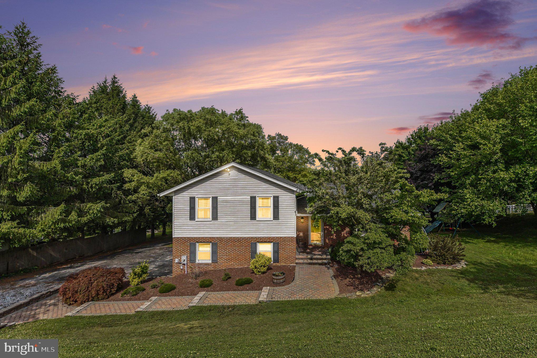 Charming Split Level Home with 1 Car Garage located on over a 1/2 Acre Lot! This home features 3 bedrooms, 2 full baths and 1-1/2 bath, 11 x 15 Trex Deck & Paver Patio, Updated Kitchen, & large 4th level storage room. Enter the home to find an open floor plan main level with gorgeous hardwood floors, spacious living rm with ceiling fan flowing into large dining room with slider leading out to updated trek deck. The updated Kitchen is perfect for entertaining with stainless steel appliances, large stainless farmhouse sink with window above to enjoy backyard views, beautiful quartz countertops, large breakfast bar, ceramic tile flooring, recess lighting and door leading to deck. Head upstairs to find a primary suite featuring the primary bedroom with carpet, large closet with efficient organizer, and on-suite bath with walk-in shower, large vanity, and ceramic tile flooring. Down the hall you will find 2 more large bedrooms both with ample closet space & carpet, a full hall bath includes ceramic tile flooring, fresh paint & tub/shower combination, and linen closet. Head downstairs to find a laundry room with coat closet, access to 4th level/storage, access to 1 car garage and access to paver patio, an updated half bath with ceramic tile flooring, and a large family room adorned with a shiplap accent wall & carpet. The unfinished lower level is ready for your finishing touches featuring high ceilings with lighting, wet sink, sump pump, updated hot water heater, room for gym equipment and tons of storage space. Enjoy the peaceful & serene, wooded views whether you're on the spacious trex deck with stairs, private paver patio, or in the 500 gallon-8 person hot tub with LED lighting.  The Rear yard includes invisible electric fence, firepit, shed and circle driveway for easy access behind the home to garage and driveway parking.  Updates Include: 2025 Hot Water Heater, 2023 Radon System, 2019 Roof, 2017 Windows, Updated Kitchen, Updated Trex Deck, Fresh Paint, & So Much More! Shed & Hot Tub are As Is. This is home is move in ready and a must see!
