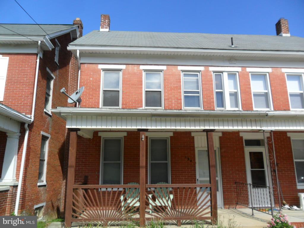 Sweet semi-detached home just waiting for your personal belongings to call it home.  1 car detached garage and then property extends out passed alley to the tree line for a great size lot.  Balcony off eat-in kitchen and off a second floor bedroom.  Nice half bath on first floor and large main bath on second floor.  Third floor bedroom or playroom has original hardwood floors and electric baseboard heat.  Why rent when you can own.  Welcome Home!