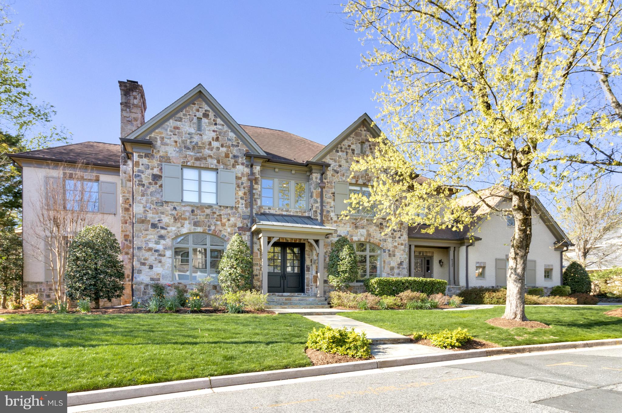 This spectacular home is located on a premium lot in sought-after Country Club Hills. A slate walkway leads to a grand double door entrance, framed by elegant stone and brickwork, with professional landscaping, including mature shade trees and thoughtfully designed privacy plantings.

With 5 bedrooms, 5 full and 2 half baths, and 8,200 sq ft of living space on three levels, the space has been transformed with nearly $600k in updates, inspired by Jodi Macklin Interior Design. The main level features 10’ ceilings, espresso-stained hardwood floors, high baseboards and crown molding. The wide central hall welcomes you to a formal living room with a cozy wood-burning fireplace and a separate dining room with wainscoting detail - both bathed in natural light from oversized windows. There is a gorgeous main level office with custom built-ins and expansive windows on three sides. A sleek wet bar, with painted black cabinets, under counter lighting and wine refrigerator, leads to the welcoming family room with a gas fireplace, coffered ceilings, and direct access to the large deck where you can enjoy seasonal views of the Washington Golf course and leafy privacy in warmer months. The impressive gourmet kitchen, with table space for informal meals with friends and family and a butlers pantry, showcases an oversized island with seating for 4, tons of cabinet storage, dramatic light fixtures and high-end appliances, including a six-burner cooktop, warming drawer, double wall ovens and two dishwashers. A family entrance with mudroom area, provides access from the three-car garage, and is conveniently located near a second main level powder room, coat closets and laundry room. Just off the kitchen, a back staircase leads to a private apartment with a full bath and large closet, perfect for accommodating in-laws, a nanny, or guests.

The upper level features the spacious primary bedroom suite, with a gas fireplace, oversized windows, two walk-in closets and a separate sitting room that could double as an additional home office. The primary bath has two separate vanities, a soaking tub and separate walk-in shower and separate water closets. Two well-proportioned ensuite bedrooms, a laundry room and a sun-soaked sitting area with custom built-ins and views of Bethesda and Chevy Chase complete this level. 

The fully finished walk-out lower level, accessed by front and rear staircases, features a bedroom, a full bath, family room with a gas fireplace, media room, exercise room, a bar, and even more flex space, with direct access to a covered stone patio. 

This meticulously maintained and beautifully designed home offers a luxurious and comfortable lifestyle in a highly desirable location. With its spacious layout, high-end finishes, and thoughtful amenities, this property is truly exceptional.