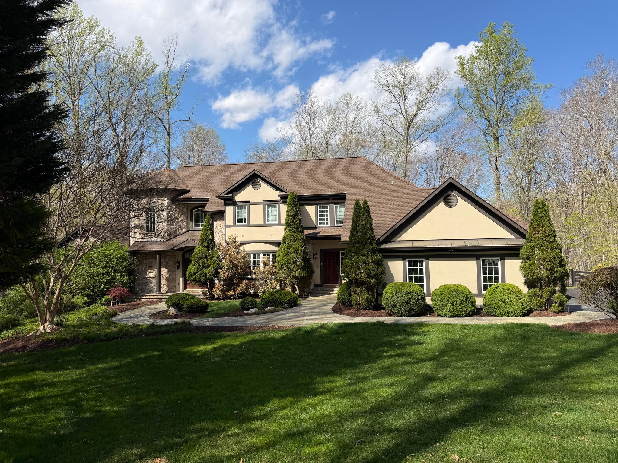 Seller Price Reduction- Don't Miss your chance to own this one of a kind custom home in River Bend!

Tucked at the end of a private cul-de-sac on nearly 8 wooded acres, this extraordinary home
feels like a world apart, yet sits minutes from downtown Manassas, everyday conveniences, and
quick access to Routes 234, 66, 95, and 28. The mature tree canopy provides complete privacy
from the street and neighbors alike, and the resort-like setting announces itself before you ever
step through the door.

The connection to the outdoors here is exceptional. The property holds over 100 feet of
private frontage on the Occoquan River, with a dock perfect for launching kayaks, canoes,
and paddleboards into miles of open waterway. A private trail leads directly from the home
down to the water’s edge, and from there residents have access to a mile-long community
trail running right along the banks of the Occoquan. A serene, wooded path ideal for
morning walks, dog lovers, and families who want time along the river without ever getting in a
car. Two streams also border the property and feed into the river, adding to the sense of living
within nature rather than simply beside it.

Outside, the home lives like a private resort. A pool and spa anchor the backyard entertaining
space, with the walk-out basement connecting seamlessly to the pool deck. Tucked beneath the
deck is a covered outdoor area with its own gas fireplace, a perfect perch for cool evenings by
the pool or watching football on a crisp fall afternoon. The three-car garage handles vehicles
and gear with ease, and a large, nearly new shed offers additional space for watercraft, garden
tools, or workshop use. The wooded acreage surrounds it all, providing shade, privacy, and the
sounds of the natural world at every turn.

Inside, the home is appointed with five gas fireplaces in total, lending warmth and ambiance
to the living spaces throughout every season. The primary suite sits on the main living
level, a thoughtful layout that offers both convenience and seclusion, complete with two
generous walk-in closets and views into the trees. A light-filled flex room off the kitchen
works beautifully as a home office, breakfast room, or reading space. Three large bedrooms
occupy the upper level, and the walk-out basement adds a fourth bedroom with a full bath
opening directly onto the pool deck. All this alongside a remarkable 1,000 square foot
climate-controlled storage area. Combined with oversized closets throughout the home,
the three-car garage, and the outbuilding shed, storage here is genuinely without equal.

This is not simply a large home — it is a lifestyle. Mornings here begin with birdsong, the
rustling of leaves, and the deep green stillness of the woods — a natural soundtrack that
sets the tone for the day. It is a place where adults rediscover tranquility and children
thrive outdoors, where the pace slows and the noise of the world fades. And yet, everything
you need is close at hand — major commuter routes, shops, and amenities all within easy
reach. Peaceful and private, yet effortlessly connected. Properties that offer this rare
balance are extraordinarily hard to find. This is one of them.