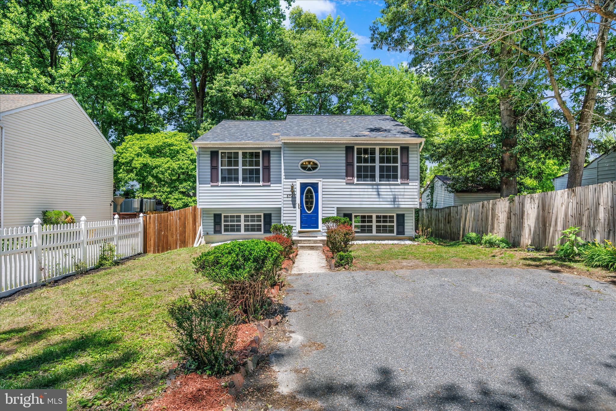 Tucked at the end of a quiet street with no through traffic, this move-in-ready three-bedroom home offers comfort, space, views of woods, and thoughtful updates throughout. The updated kitchen features soft-close cabinetry and drawers, a beautiful glass subway tile backsplash, and a GE appliance package. There is dining space in the large kitchen. The spacious primary suite with full bath was expanded by incorporating space from the original third bedroom, creating a generous retreat with a large walk-in closet and/or flexible space ideal for a home office, nursery, reading nook, or workout area. There is a second bedroom and a full hall bath also on this level. Hardwood flooring runs through the hallway and living room, while the bedrooms feature newer carpeting. The lower level includes the third bedroom, a large family room, and a separate laundry and utility room, providing plenty of functional living space. Through the slider doorway, there are four steps up to a beautiful paver patio that spans the width of the home, creating a great setting for outdoor entertaining or relaxing. The fully fenced backyard offers room for pets, play, or gardening, and a storage shed (As Is) provides additional space for tools and equipment. With flexible living spaces, indoor and outdoor areas to enjoy, and updates already in place, this home is ready for its next owner to move right in and make it their own. The Roof was replaced in August 2025.