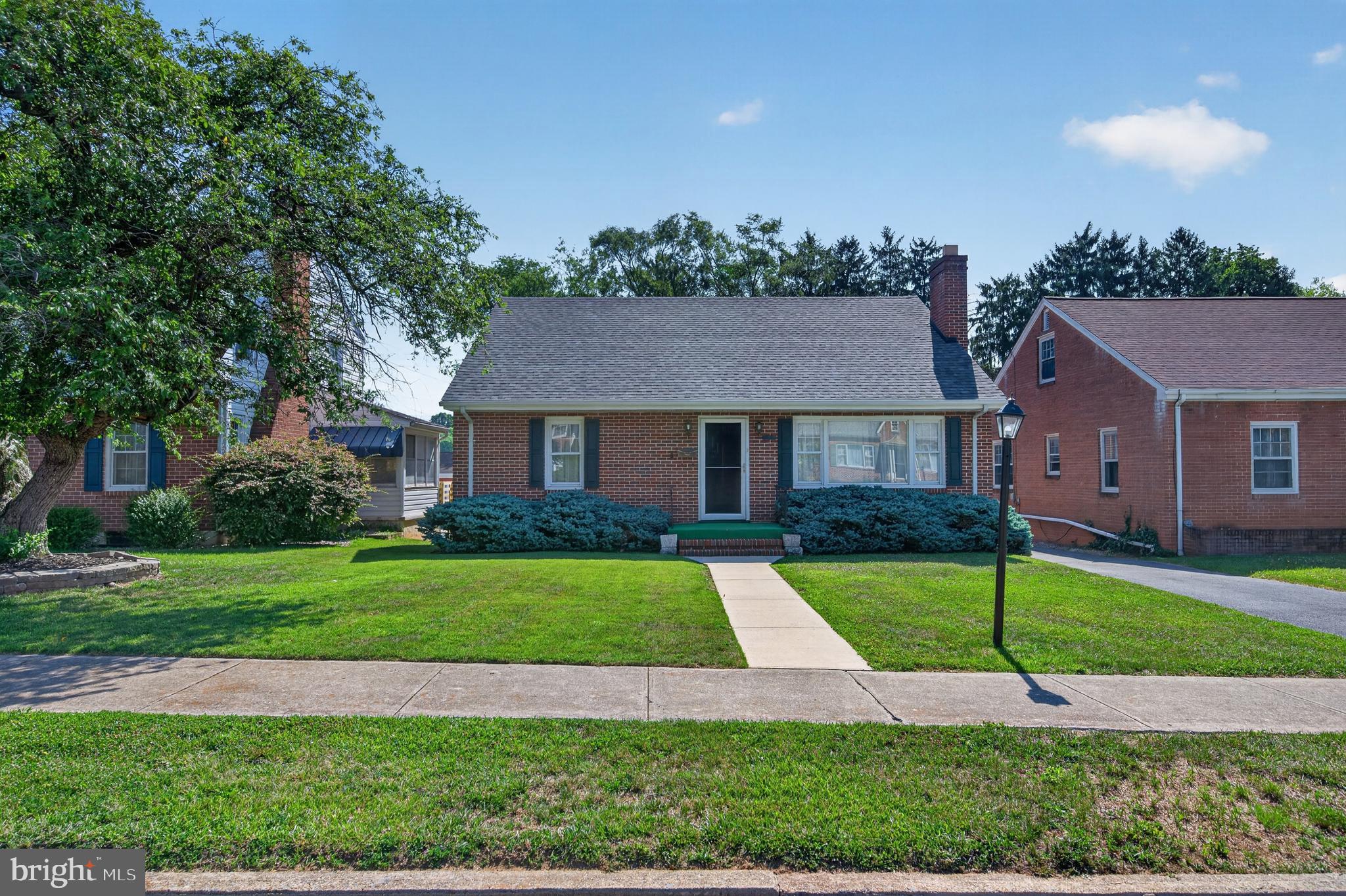This charming ranch-style home in the heart of Martinsburg offers a perfect blend of comfort and functionality. Built in 1952, this well-maintained brick residence features 1,613 sq. ft. of inviting living space, ideal for creating lasting memories. Step inside to discover beautiful hardwood floors that flow throughout the main living areas, complemented by warm natural light filtering through replacement windows. The spacious formal dining room is perfect for gatherings, while the cozy living room boasts a brick fireplace with glass doors, creating a welcoming ambiance for relaxation. The kitchen comes equipped with essential appliances, ensuring convenience for everyday living. With three bedrooms, including an entry-level option, there’s ample space for everyone. The home also features built-ins and a cedar closet, providing both style and storage solutions. Outside, enjoy the community amenities, including an in-ground pool, perfect for those warm summer days. The property includes a detached garage and an asphalt driveway with space for multiple vehicles, making parking a breeze. Set on a 0.17-acre lot with sidewalks, this home is not just a place to live, but a place to thrive. Experience the warmth and charm of this delightful residence, where every detail has been thoughtfully considered for your comfort and enjoyment.