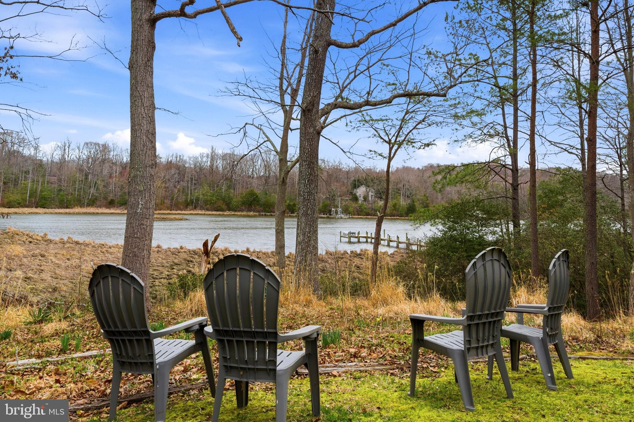 STUNNING WATERFRONT! Set on 2.21 private acres along St. Leonard Creek, this exceptional waterfront home offers 4,468 square feet, 4 bedrooms, 4.5 bathrooms, a detached 2-car garage w/ an unfinished storage space above, and a fully finished basement in a setting that feels private, peaceful, and made for everyday luxury. Watch the numerous Bald Eagles and other wildlife and melt away into this scenic vista's natural beauty!

Inside, Anderson windows and doors bring in natural light and frame beautiful views of the water and surrounding trees. The main level is designed for both comfort and entertaining, with spacious gathering areas, warm wood details, and seamless flow from room to room. Upon entry you are greeted by expansive creek/nature views. The oversized main floor half bath is located just to the left. The large sunken living room boasts floor to ceiling windows and a cozy gas fireplace. Adjacent to the living room, the formal dining room features a built-in buffet area with a wine fridge and a glass door with access to the large rear deck. The chef's kitchen is well appointed with luxury appliances including a double wall oven, side by side refrigerator, built-in microwave, glass induction cooktop, bosch dishwasher and a warming drawer. The solid wood cabinets, quartz countertops, and custom tile backsplash add to the elegance of the space. Just off the kitchen, the family room features a wood stove insert with a 2-story brick facade, creating a cozy and inviting space to relax. 

The main level primary suite offers the ease of first-floor living along with a spacious bath featuring heated travertine tile floors and a jetted soaking tub, creating a true retreat.

Upstairs, the home’s spacious feel continues with two generously sized bedrooms, including a private upper-level primary-style suite with its own sitting area which overlooks the family room. The upper level primary bedrooms features include a walk-in closet, a private balcony and an en-suite bath which boasts a double sink vanity, ceramic tile flooring, a soaking tub, and a separate tiled shower. The hall bath, which serves the additional oversized bedroom on this floor, includes granite countertops and a skylight, bringing in soft natural light and adding to the airy feel of the upper level.

The lower level expands the home’s flexibility even further with a large recreation room or possible 4th bedroom/in-law suite, outdoor access to  a wonderful patio area, a wood stove insert, a full bath, and a laundry area with storage space—ideal for entertaining, guests, hobbies, or everyday convenience.

Outside, the property truly shines. A large Trex deck, accessible from both the kitchen and dining room, overlooks the private backyard and the gorgeous natural setting of St. Leonard Creek , creating the perfect place for outdoor dining, morning coffee, or evenings by the water. The detached two-car garage with an unfinished space above adds even more versatility.

With water views, generous indoor and outdoor living areas, and a peaceful setting on St. Leonard Creek, this is a rare opportunity to enjoy the kind of waterfront lifestyle that feels like a getaway every day. Set up a showing ASAP so you don't miss this opportunity!