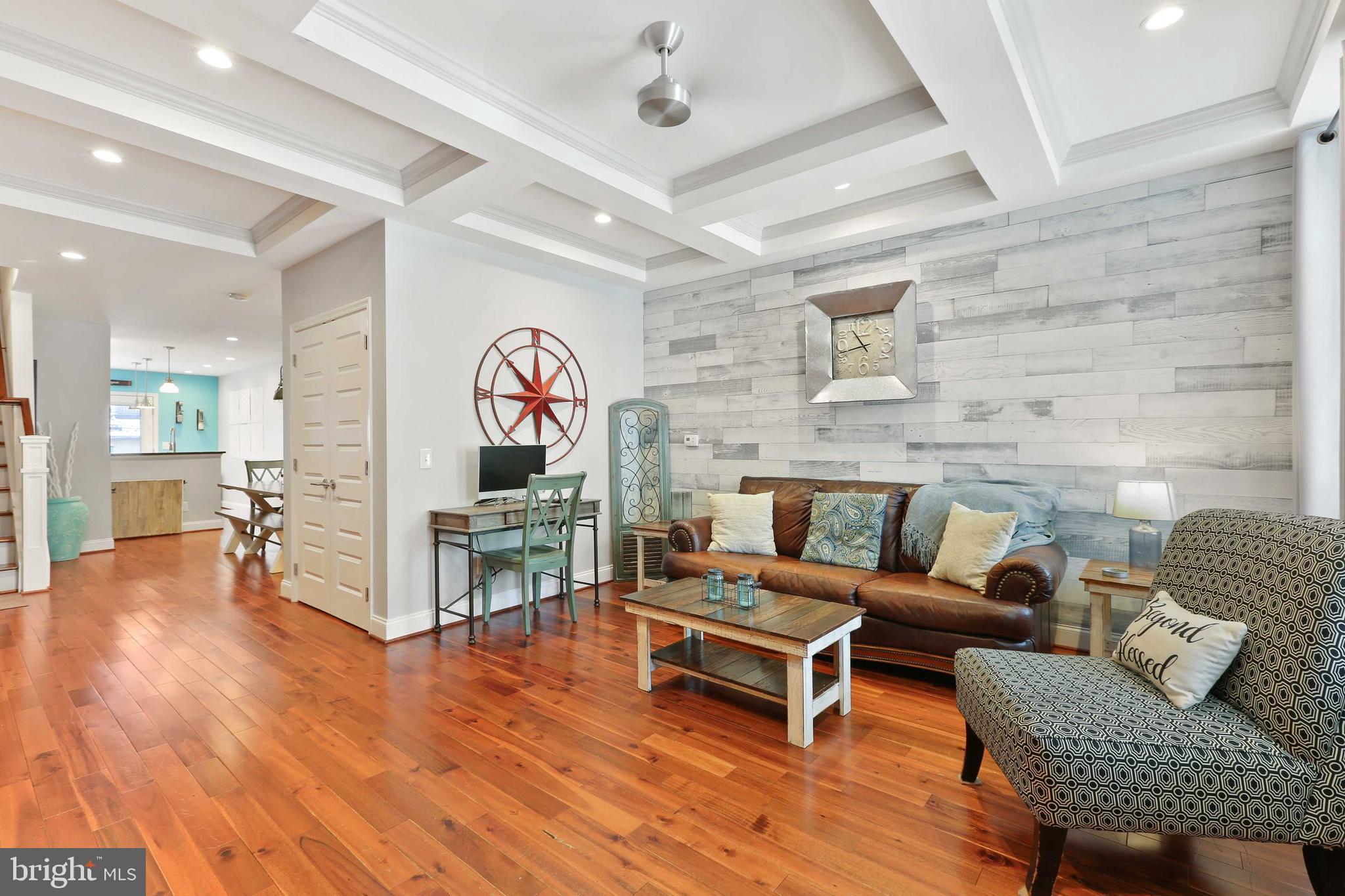 Stunning recently renovated home with 5 years left on CHAP! This wide home has hardwood floors throughout. Living room with coffered ceiling, exposed brick and recessed lighting. Dining area with built-in wet bar. Kitchen has white shaker cabinets, subway tile back splash, island, stainless steel appliances and exhaust hood. Back deck off kitchen. Primary bedroom with en suite bath with stand up shower and huge walk-in closet with custom closet organizer. Second bedroom and full bath on upper level.  Custom built-in closets  throughout upper level. Fabulous roof top deck! Full finished WALK OUT basement with full size windows, third bedroom, full bath and rec room...unbelievable space! Rare Sub Basement for additional storage.  Exit the lower level to another outdoor space...this one is a fully stoned patio...perfect for entertaining. This home is must see!