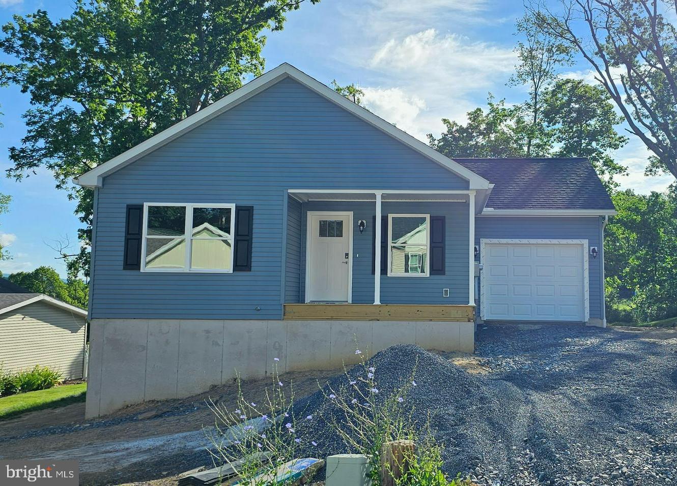 Nearly complete new construction! Visit this 3-bedroom ranch home in the Nittany Grove neighborhood in State College School District. Located just 10 minutes from Beaver Stadium, with an association fee that covers your sewer, water, trash, recycling, and lawn maintenance - this home is ideal for full OR part-time living. From entry, you'll love the cozy covered front porch leading into a sprawling living space. Luxury vinyl plank flooring flows through the entire house, except the plushly carpeted bedrooms. The kitchen features quartz countertops and stainless steel appliances. There is a back deck located off of the dining area to make grilling in the summers a breeze. The primary bedroom features an attached bathroom with double sink vanity, walk-in shower, and a huge walk-in-closet. Two additional bedrooms, back the hallway, share the full bathroom with tub shower.  A mud & laundry room is off of the extra deep one-car garage. Last but certainly not least, this home has a full, unfinished walkout basement - giving you endless storage and the possibility to finish out a great rec room, home gym, or additional bedroom for guests.