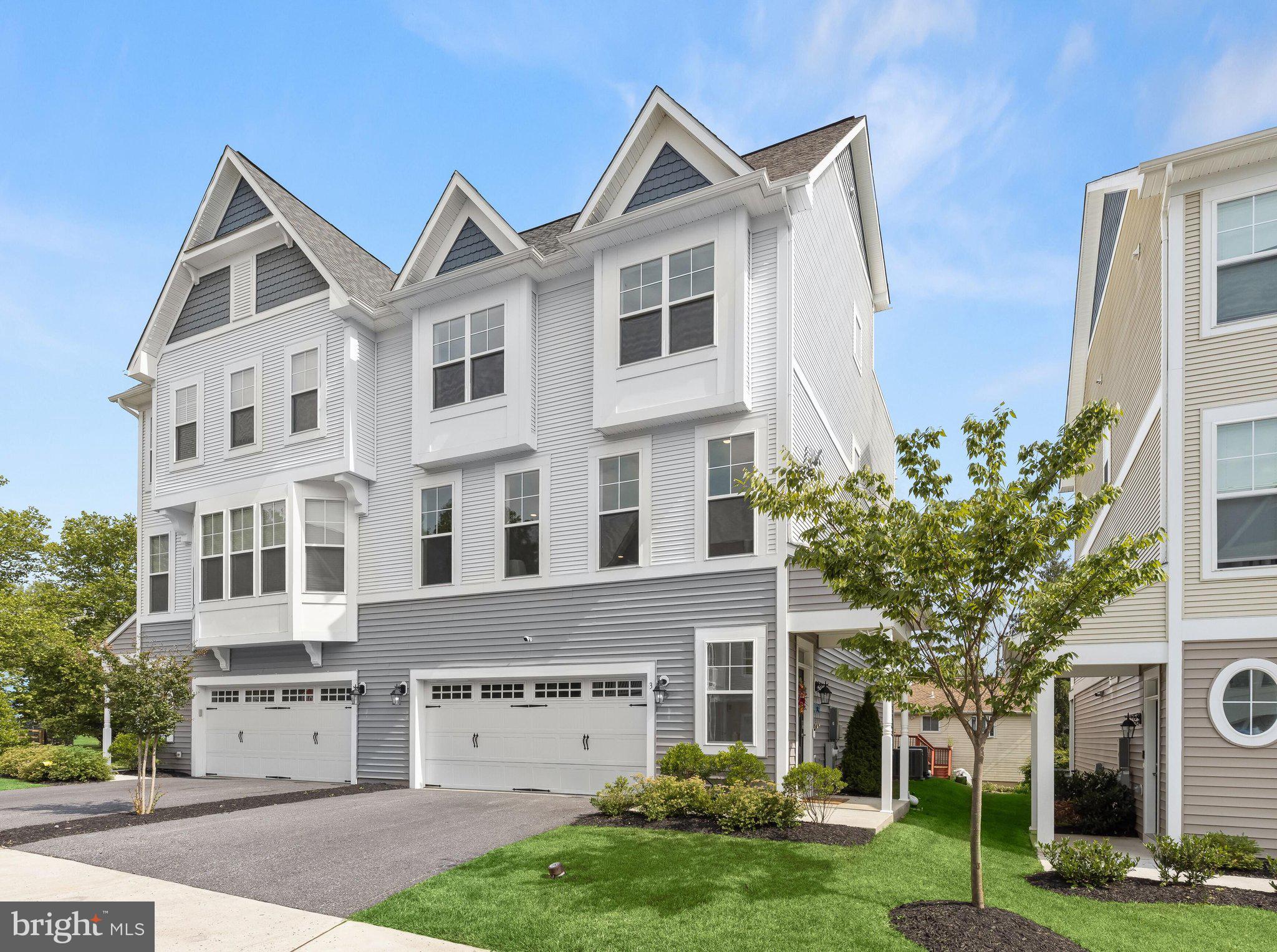 Tucked within the prestigious Victoria Crossing community near historic Glyndon, this barely lived-in 2022 residence stands as the largest model in the neighborhood, offering upgraded finishes, thoughtful design, and four finished levels for modern living. A rare fourth-level loft configuration, not found in other homes in the community, adds exceptional versatility along with access to a composite rooftop deck.
Luxury vinyl plank flooring extends throughout the main level, where a window-lined living room welcomes abundant natural light. At the center of the home, the kitchen connects the living and dining areas with bright white 42-inch cabinetry, quartz countertops, stainless steel appliances, a gas cooktop, spacious walk-in pantry, and a large island with seating. A generous dining area accommodates a sizable table, while an additional breakfast room provides even more space beyond the oversized breakfast bar. Just off the dining area, the inviting sunroom features a fireplace and offers a comfortable place to gather.
Stairs with iron balusters lead to the third level, where the primary suite includes a walk-in closet and en-suite bath with a double-sink vanity, soaking tub, and separate shower. Two additional bedrooms share a full bath, and the laundry area is conveniently located on this level.
Unlike other homes in the community, the fourth floor offers a versatile loft with a half bath and access to a composite rooftop deck, creating a memorable space for entertaining, working from home, or enjoying open-air views.
The lower level adds a family room with sliding glass door access to the backyard, along with a fourth bedroom, full bath, and interior garage access. Conveniently located near schools, Stevenson University, shopping centers, and major commuter routes including I-795, I-83, and I-695, this home pairs a prime Baltimore County location with low-maintenance living. Monthly HOA coverage includes lawn care, snow removal, exterior upkeep, and common-area maintenance, allowing residents to enjoy all that Victoria Crossing has to offer.