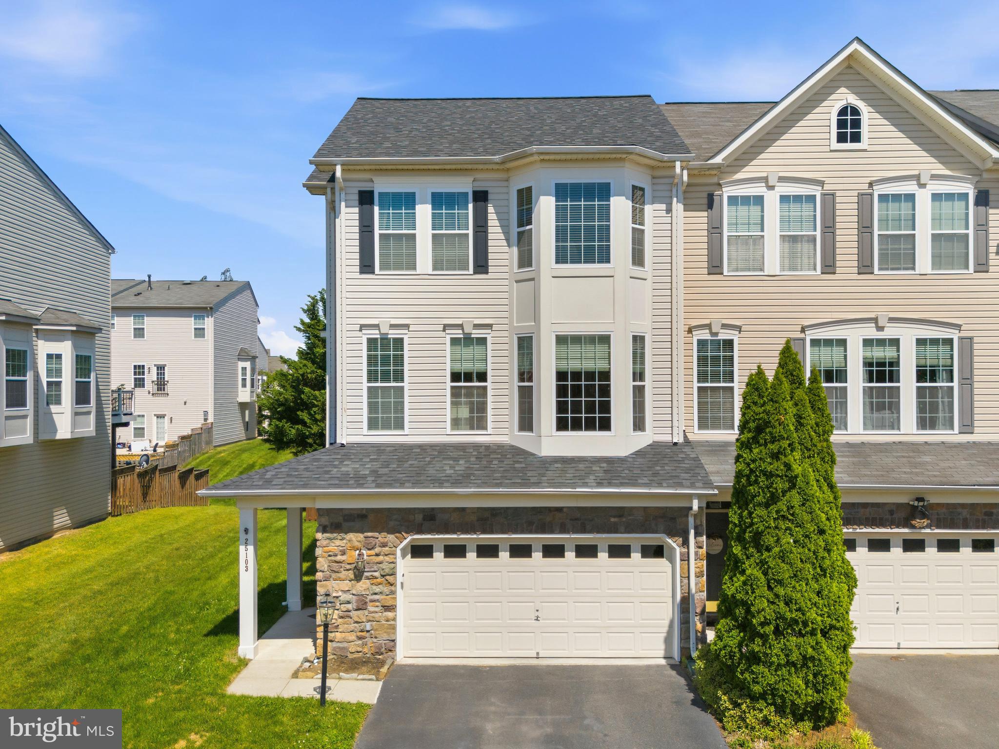 Perfectly positioned end unit, this oversized former model home by Van Meter Homes offers a single family size feel and is loaded with all the bells and whistles!  Bonus side windows fill the interior with abundant natural light PLUS  3 level extension!  As you enter, you'll discover custom upgrades to include elegant moldings in many rooms, a built-in bay window bench, and numerous designer touches including an exceptional finished garage with storage racks!

A dramatic two-story foyer welcomes you and leads to beautiful glass French doors that open into a recreation room that can serve as a fourth-bedroom suite, complete with a full bath, fireplace and rear walk-out access to a privately fenced backyard with a paved patio. The main level features pristine hardwood flooring throughout, a formal dining room, and a spacious living room ideal for open-concept living.

The elegant gourmet kitchen features a center island, custom backsplash, NEW appliances, and ample space for a casual sitting area or breakfast room.   Direct access to the deck allows for seamless indoor-outdoor enjoyment. Upstairs, the generously sized bedrooms provide comfortable accommodations, including an impressive primary suite featuring custom organizers in walk-in closet and a spa-inspired ensuite bath boasting a steam shower/Sauna, waterfall shower head,  heated floors & towel racks-  luxury appointments you've dreamed about!    Relax and enjoy a private backyard with a spiral staircase from the deck for easy access to your landscaped garden.  This home encompasses exceptional space, style, functionality and location!   Here are other upgraded features: ** 4 Yr Old Tankless water heater and water softening system, Roof 2 Years Old,  side-mounted jack shaft garage door opener (very quiet DC motor) with video keypad** Recessed and Custom Light fixtures** Stone Accent Elevation**Upper Level Laundry!
