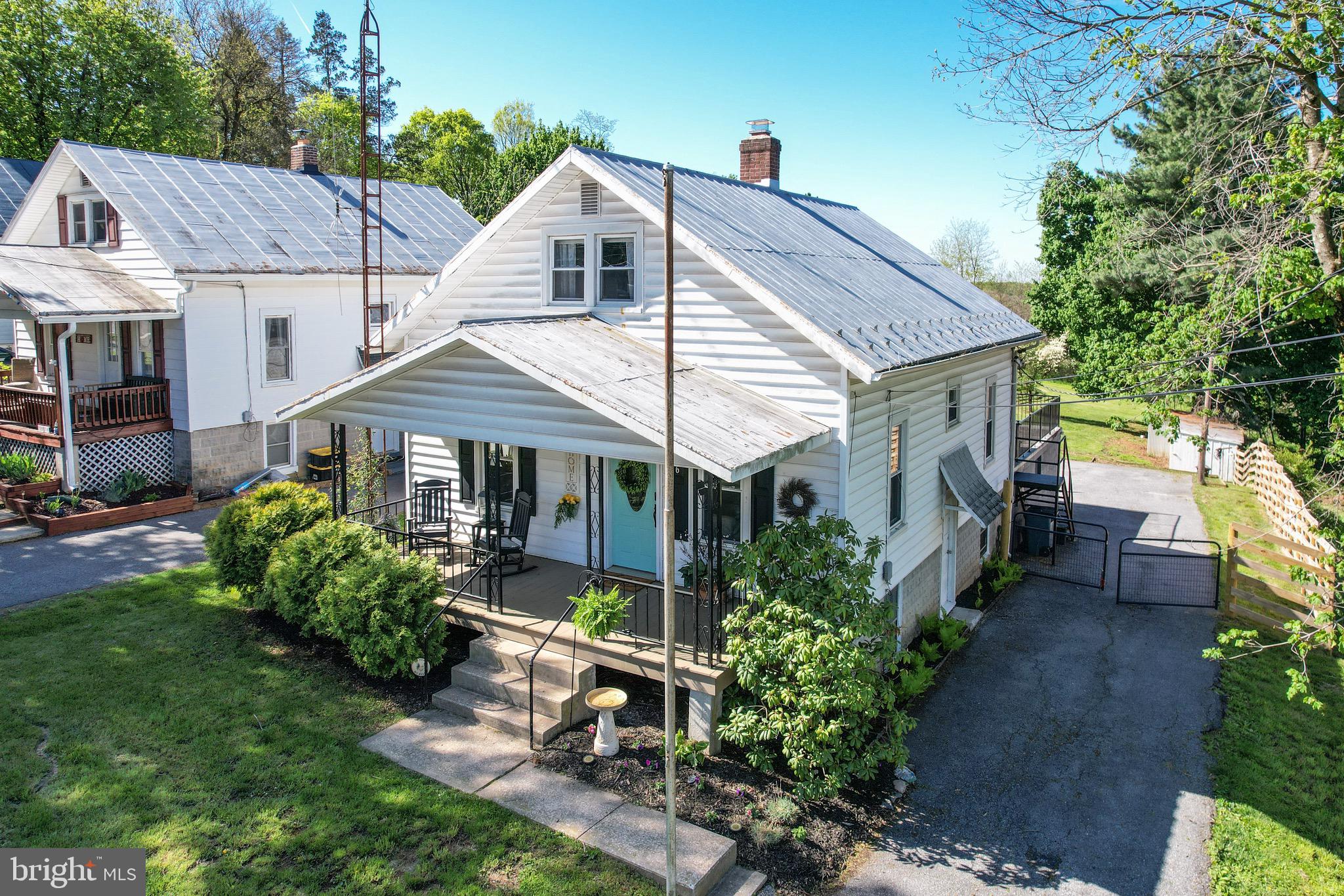 Tucked along picturesque Littlestown Pike in Westminster, MD this enchanting property captures the essence of a storybook cottage with a setting that feels both serene and inspiring. From the moment you arrive, you’re greeted by a sense of calm, where  the gentle rhythm of the countryside invites you to slow down and stay awhile.
A welcoming front porch sets the tone for the home, perfect for long, leisurely mornings with coffee or quiet evenings spent porch sitting as the sun dips below the horizon. It’s an inviting space that naturally becomes part of everyday living. Ideal for conversation, relaxation, and taking in the peaceful surroundings.
Inside, this charming two bedroom, one bath home is filled with warmth and character, where cozy spaces blend effortlessly with natural light. Every window offers a glimpse of the surrounding landscape, creating a seamless connection between indoors and out. It’s the kind of place where mornings begin with sunlight streaming in and evenings wind down with a soft, breezy tranquility.
Outside, the property truly shines with a large, open lawn that offers endless possibilities! From gardening and recreation to hosting gatherings on the large back porch. The two car garage along with a large outbuilding add both function and flexibility, perfect for storage, hobbies, or creative use. Expansive views and fresh air enhance the atmosphere. Ideal for quiet reflection, entertaining, or simply enjoying the beauty of nature on over a half of an acre!
Adding to its appeal, this home represents a rare opportunity as one of the least expensive detached properties in Carroll County, Maryland, offering exceptional value without sacrificing charm, space, or setting.