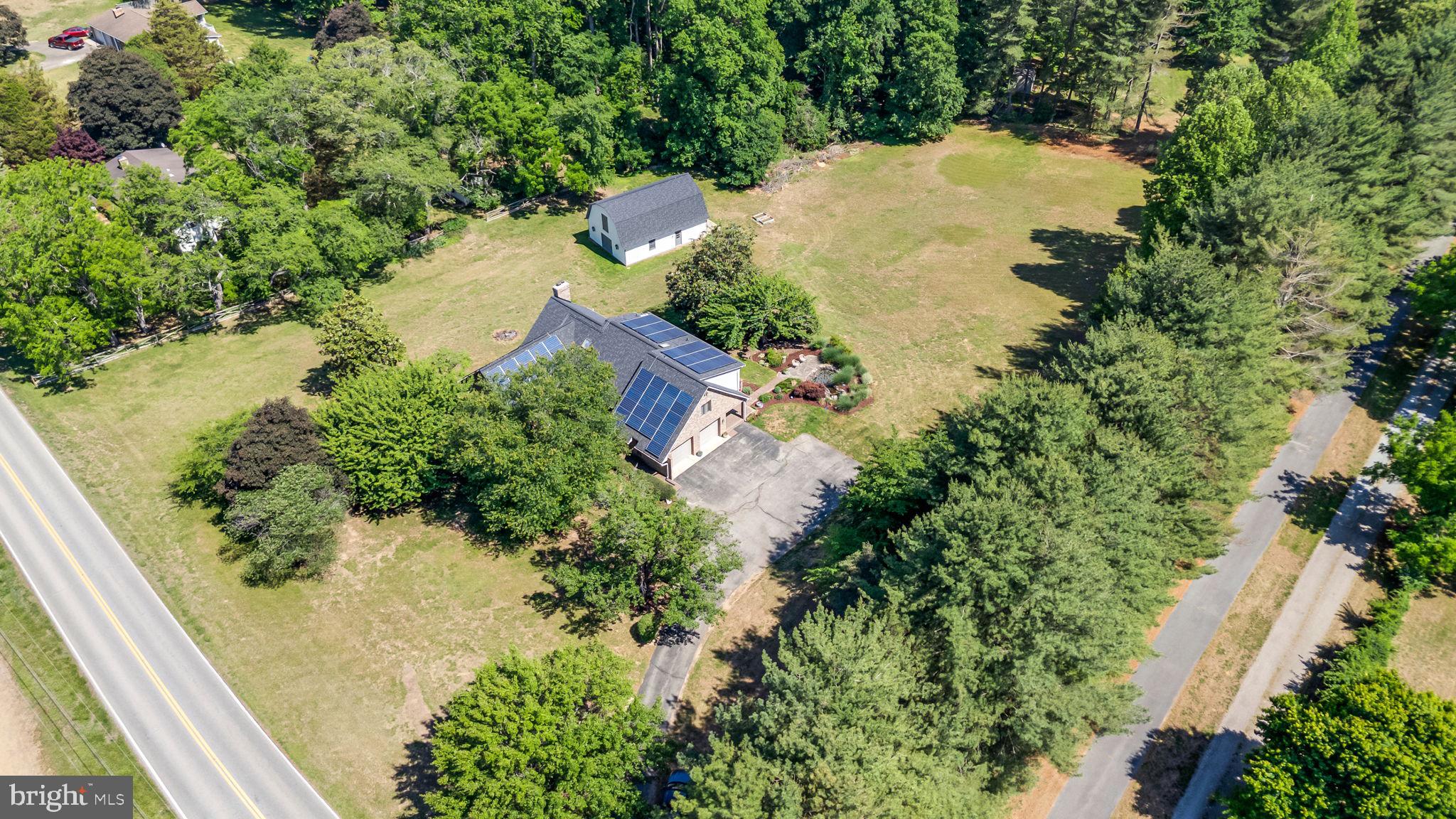 Welcome to one of Huntingtown's most exceptional properties—a truly one-of-a-kind all-brick estate situated on 3 beautiful, usable acres in one of Calvert County's most sought-after locations. Offering timeless craftsmanship, modern updates, and endless possibilities, this remarkable home is the perfect blend of luxury, comfort, and functionality—all with no HOA.

Step inside and be greeted by gleaming, newly refinished hardwood floors, soaring vaulted ceilings, skylights, and oversized casement windows that flood the home with natural light. The spacious main-level primary suite is a private retreat featuring a separate sitting room, walk-in closet, and spa-inspired bath with a soaking tub and separate shower.

The heart of the home is the impressive great room, showcasing a stunning floor-to-ceiling brick wood-burning fireplace, a dramatic wall of windows, and a wet bar—creating the perfect gathering space for entertaining family and friends.

The beautifully renovated kitchen offers stainless steel appliances, abundant cabinetry, and easy access to the charming brick patio, making outdoor dining and grilling effortless.

Upstairs, you'll find three generously sized bedrooms, two full bathrooms, and a versatile loft overlooking the great room—ideal for a reading nook, home office, or play area.

The fully finished walk-out lower level expands your living options with an incredible entertainment area featuring a full wraparound bar, dishwasher, beverage cooler, and commercial-grade nugget ice maker—an entertainer's dream. The lower level also includes two additional bedrooms, a full bathroom, and a spacious workshop. With private access, this space offers excellent potential for multigenerational living, guest quarters, or even a separate apartment to help offset your mortgage.

Outside, the massive detached barn/garage is a rare find. Complete with electric service and a half bath, it offers room for 4-6 vehicles, equipment, hobbies, or business use. With its expansive loft, the structure could easily be converted into a traditional barn for animals, while still providing ample storage for hay, equipment, or recreational vehicles.

Additional updates and features include:
• Newer roof
• New water heater
• Both HVAC systems replaced within the last two years
• Water softener installed in 2023
• Both dishwashers approximately one year old
• Newer washer and dryer
• Radon mitigation system installed

This extraordinary property combines privacy, versatility, and convenience in one of Huntingtown's most desirable settings. Whether you're looking for room to grow, space for hobbies and animals, multigenerational living, or simply a stunning home with exceptional amenities, this property truly offers it all.