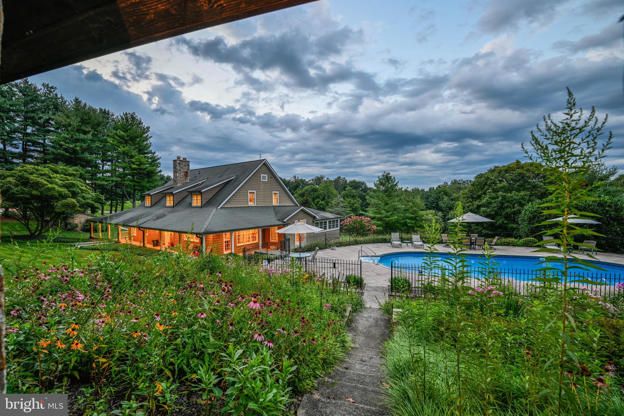 ACTIVE UNDER CONTRACT WITH KICKOUT. 

Live authentically. Take the road less traveled. Look forward to driving the country lane meandering through the trees and arriving home. Nestled on a sprawling expanse of 19.90 acres. A farm that will stand the test of time, both enchanting and enduring. Lose yourself in the stillness. 

Exudes a harmonious aesthetic. A soothing neutral palette. The quality of millwork and workmanship is palpable throughout. Open kitchen and gathering spaces. A porch made for living that wraps three sides, an architectural element that will elevate your enjoyment. Offers a tranquil oasis where you can bask in the mesmerizing dance of sunlight filtering through the surrounding foliage. This picturesque vantage point becomes your front-row seat to witness the ever-changing canvas of nature's happenings.

The windows serve as both portals to the outside world and artful frames through which you can appreciate the beauty of every season. They beckon you to gaze out onto the poolside, a deep blue sanctuary that promises a refreshing dip.

Thoughtfully sited and meticulously built barn and outbuilding created with a skilled eye and a passion for maximizing functionality. Delight in the strength of an Amish-constructed barn. This barn, with its weathered timbers and rugged charm houses an ample workshop, stalls, and a loft. A very versatile space. Luxe chicken house. The ultimate ventilated outbuilding to store wood and multiple generators.

A destination pavilion with a strong sheltering roof. A place you will want to spend time and take in the vistas beyond overlooking the wildflower gardens and shimmering pool. Soak in the atmosphere, enveloped by the lush greenery that surrounds the property. Let your cares drift away as the gentle breeze carries whispers of serenity and the calming sounds of water.

Lower-level lives as a pool house/party barn within the main house, stylish concrete floors, ample gym, billiards, and bar. 

This home tells a story of rustic elegance infused in a modern farmhouse. You're not merely a resident; you're an observer of nature's symphony, a steward of a slice of timeless beauty that melds the past with the present in perfect harmony. Cultivate your existence. Please book your appointment now. In the event the active date changes, you will be notified. The art of uniting human and home. Please do not visit without an appointment. Property is subject to Conservation Easement.