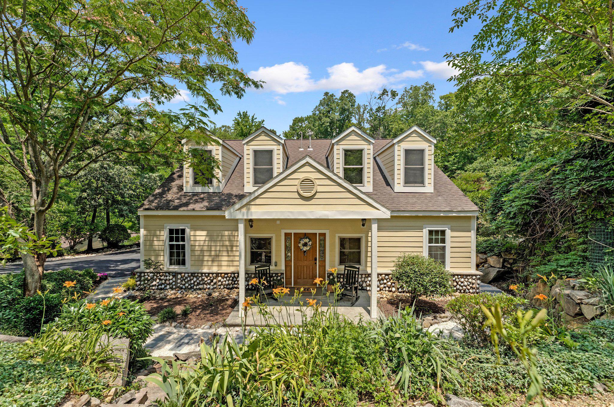 A hidden oasis where the trails begin!  Tucked into a lush, private half-acre in Lorton's Mason Neck, this custom home is a rare find in Fairfax County. A true zen oasis with meandering paths through meticulous landscaping and mountain bike and hiking trails at your back door. Mason Neck State Park, Pohick Bay Regional Park, and Gunston Hall just minutes away. 

Inside, Pride of ownership is evident throughout this thoughtfully designed home. Offering five bedrooms plus a dedicated office, including a private upper-level suite complete with its own entrance, kitchenette, and sun deck, the flexible floor plan is ideal for multigenerational living, guests, remote work, or extended stays.  

The exterior is equally impressive with Hardie Plank and stone siding, a detached workshop garage, brand-new asphalt driveway, and beautifully landscaped grounds designed to blend seamlessly with the surrounding natural environment. The detached garage offers outstanding workshop space and is roughed in for future plumbing, creating endless possibilities for hobbyists, mechanics, or future expansion. Brand-new asphalt driveway. No HOA.

Extensively upgraded for comfort, efficiency, and future readiness, the home features a newly completed 400-amp electrical heavy-up that distinguishes this home from ordinary. The upgraded service provides exceptional capacity for today's technology-rich, energy-intensive households and is fully configured for the addition of multiple EV charging stations.

The geothermal system at the heart of this home is a custom, two-zone installation — one of the most efficient and durable climate solutions available for a residential property. An electric heat pack provides backup heating capacity, ensuring performance even in the coldest weather. The system is divided into independently controlled zones for personalized comfort throughout the home, and delivers consistent year-round temperature management at dramatically reduced utility costs compared to conventional HVAC. A whole-house steam humidifier maintains healthy indoor air quality, and a high-MERV advanced air filtration system keeps airborne allergens and particulates in check. 

Two premium Stiebel Eltron tankless water heaters — positioned at the bathrooms they serve — deliver instant hot water on demand with minimal waste. An additional 80-gallon water heater provides whole-house capacity for high-demand situations.  

This thoughtfully designed home boasts efficiency, comfort, and functionality in alluring Mason Neck.  Perfect for multigenerational living, home-based businesses, hobbyists, outdoor enthusiasts, and anyone seeking a private retreat without sacrificing convenience. It’s not just a home, it’s a lifestyle.
