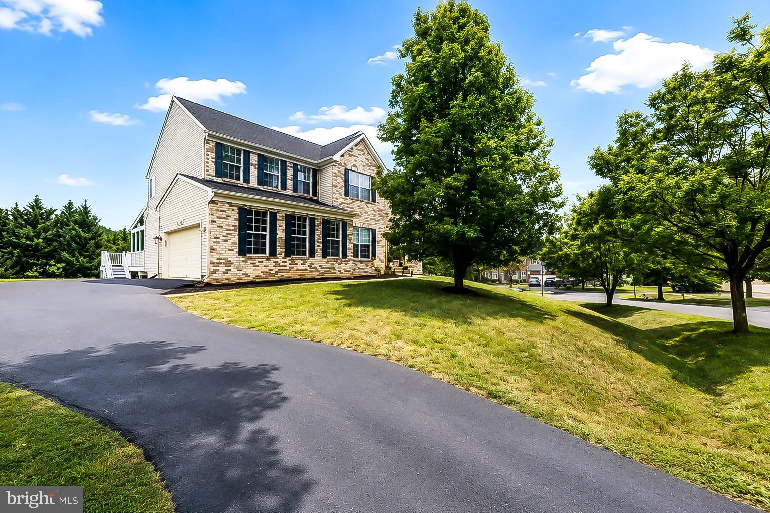 Welcome to this beautifully updated and meticulously maintained hilltop home, offering timeless elegance, quality craftsmanship, and extensive upgrades throughout. Located in the highly desirable Kings Crossing community, this move-in-ready residence combines spacious living with exceptional indoor and outdoor entertaining spaces.
The inviting main level features a formal living room and dining room accented with crown molding, a dramatic two-story family room with a stunning floor-to-ceiling stone fireplace, recessed lighting, hardwood flooring throughout, and 9-foot ceilings. A private home office and powder room add everyday convenience. The gourmet kitchen is equipped with stainless steel appliances, a cooktop, wall oven with built-in microwave, abundant counter space, and opens to a beautiful glass-enclosed porch as well as a spacious deck—perfect for year-round enjoyment. From the backyard, enjoy spectacular July 4th fireworks displays. A two-car attached garage completes the main level.
Upstairs, hardwood flooring continues throughout. The spacious primary suite features a vaulted ceiling, a large walk-in closet, and a beautifully renovated spa-inspired bath with a soaking tub and separate glass-enclosed shower. Three additional generously sized bedrooms provide ample space, with two offering walk-in closets. The renovated hall bathroom (2021) features a stylish glass-enclosed walk-in shower. An upper-level laundry room with a full-size washer and dryer adds everyday convenience.
The fully finished walkout lower level offers abundant additional living space, including a bright recreation room, a versatile bonus room ideal for a guest room, home office, or fitness area, a full bathroom, and direct access to the backyard.
Significant recent updates include a new roof (2021), upper-level furnace (2023), lower HVAC system (2024), and water heater (2016), providing peace of mind for years to come.
Residents of Kings Crossing enjoy outstanding community amenities including a swimming pool, tennis courts, playgrounds, walking trails, and expansive green spaces. Ideally located just minutes from the Maryland SoccerPlex, Black Hill Regional Park, shopping, dining, and major commuter routes including I-270, I-200 (ICC), and MARC Train service, this home offers the perfect combination of neighborhood charm and everyday convenience.
With its impressive updates, spacious floor plan, exceptional outdoor living, and prime Boyds location, this is a rare opportunity to own a truly move-in-ready home in one of the area’s most sought-after communities.