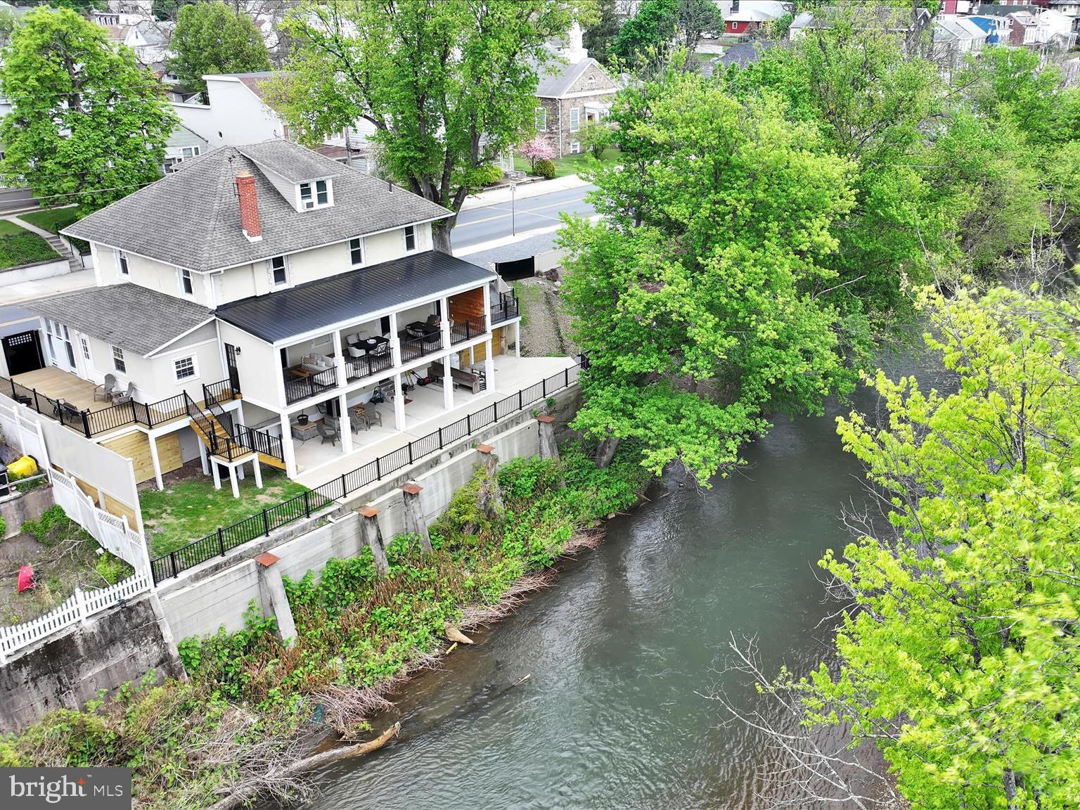 FRESHLY RENNOVATED and MOVE-IN READY! This absolutely stunning 4BR/2.5BA historic Colonial boasts a generous offering of recent updates and upgrades as well as direct and private river access and unbelievable scenic views.  Offering additional off-road parking, .09 acre 63-03-0259.000 parcel included in sale for a total of 0.29 acre. Welcome to a beautifully reimagined 1920s home, where timeless character meets modern sophistication — all perched above the Schuylkill River.  This completely updated gem features an inviting main floor with a spacious living room, dining area, and a stunning kitchen boasting dual farm sinks, bright cabinetry, and solid tile flooring. A flex room, office nook, and French doors opening to an endearing, semi-enclosed balcony overlooking the river complete this level. Thoughtful details like shiplap accents, open shelving, attractive paint colors a built-in window seat and a gorgeous authentic wood staircase add undeniable charm throughout. Upstairs, three spacious bedrooms showcase hardwood flooring, while the primary bedroom offers an en-suite bath and an extra-large walk-in closet with built-ins. A remodeled, full bathroom and a cozy office nook situated perfectly within the center of this level add additional appeal. The trendy attic serves as a fourth bedroom with a large amount of closet space. Step outside to enjoy a striking five-pillar balcony with recessed sensor lighting added in 2021, a lower-level river-view patio installed in 2023, and private river access via recently added stairs. The deck off the kitchen is perfect for grilling. A privacy screen adds serenity. Notable RECENT upgrades: steel strapping added in basement in 2026, professional overhaul on basement floor in 2026, significant concrete retaining wall repair in 2023, replacement windows, central air, heat pump, Lutron lighting system, plantation-style shutters, stainless steel appliances, and a 2024 Bradford White water heater, new electrical panel box 2026. Located steps from the Schuylkill River Trail Boat Launch, Island Park and river trail, Schuylkill Haven train station, local schools/sports fields/track,  grocery shopping, and restaurants — convenience is truly at your doorstep. A nearby newer hospital and major highways all add location highlights; enjoy the close proximity while retreating to your own private sanctuary. Schedule your private tour and enjoy - pride of ownership is remarkably evident and the homeowners have worked tirelessly to create a downtown masterpiece.