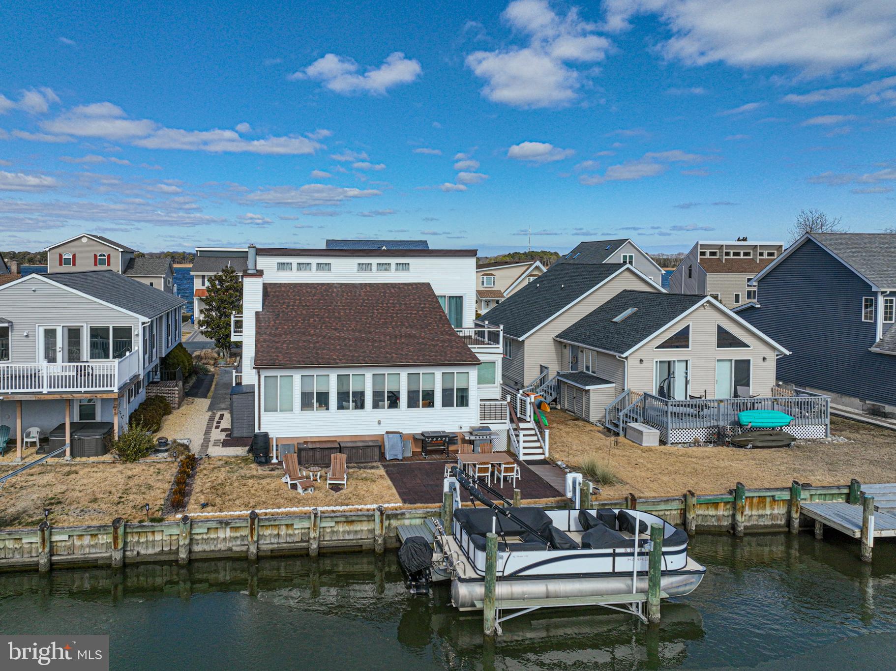 Waterfront living at its finest in sought-after Ocean Pines! Perfectly positioned just a one-minute walk to the Ocean Pines Swim & Racquet Club, this beautifully maintained 3-bedroom, 2.5-bath home offers an unbeatable combination of location, lifestyle, and value—with ample parking for all your guests and major recent upgrades including a new roof and HVAC system (2022) and a brand-new boat lift and dock (2024). Set on a protected canal just seconds from the river and bay by boat—with no bridge navigation—this property is ideal for effortless boating. Enjoy easy access to the riverfront pool, kids’ splash zone, tennis courts, and sandy beach, making this one of the most desirable locations in the community.

Inside, the home offers a welcoming main living room with a cozy fireplace, an updated kitchen featuring modern cabinetry and appliances, custom blinds in the first-floor canal-side room, and a thoughtfully renovated office or spare bunk room upstairs. Sliding doors throughout the home have been replaced, enhancing both style and efficiency. The home also features multiple decks finished with low-maintenance Trex decking for easy outdoor living. Step outside and unwind in your private hot tub while enjoying peaceful water views and coastal breezes.

Significant updates add peace of mind, including a new roof and HVAC system installed in 2022, an additional split HVAC unit added upstairs for enhanced comfort, a new boat lift and dock replacement completed in 2024, and an updated electrical panel in 2025. The downstairs bathroom has also been updated, the main water shut-off valve replaced, and additional interior improvements completed in 2025, reflecting pride of ownership throughout.

Set on a protected canal just off the St. Martin River, the home provides direct boating access to the river and surrounding back bays in mere seconds. Whether you’re cruising the St. Martin River, Isle of Wight Bay, Assawoman Bay, or the back bays of Assateague Island, this property delivers the ultimate boating and beach lifestyle.

The property is conveyed fully furnished, creating a seamless and truly turnkey opportunity for full-time living or a coastal retreat. Thoughtfully selected furnishings are included to complement the home’s design and comfort.

Located in the desirable Ocean Pines community, known for its low fees and outstanding amenities, this waterfront retreat is ideal as a primary residence or second home. This is coastal living at its best—schedule your private tour today!