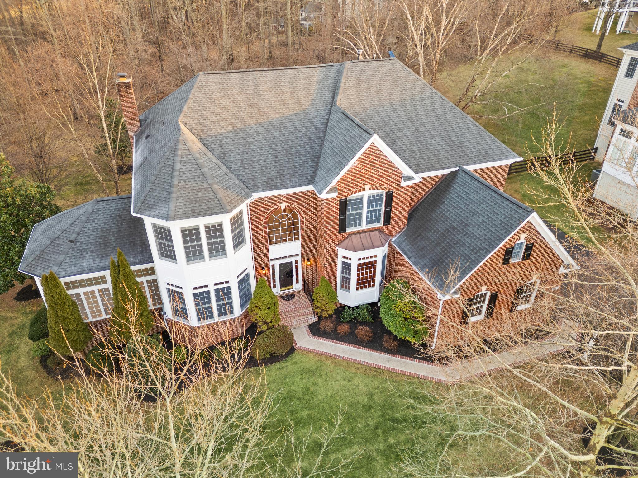 Embraced by the tranquility of the Natural Conservancy, this beautiful 5-bedroom, 4.5-bath home offers the perfect balance of peaceful seclusion and everyday convenience on one of the best, private and protected lots in the highly regarded Lenah Run community.  You will enjoy direct access to scenic walking trails, a neighborhood playground, and a refreshing community pool — all just moments from essential dining, shopping, entertainment, Middleburg, wine/horse country, and transit. Set on almost three-fourths of an acre, this expanded home is a true haven. Step into the grand two-story foyer, where you’ll immediately appreciate the gleaming refinished hardwood floors that span the main level. The dining room features crown molding, chair rail, and abundant natural light, creating an inviting space for gatherings. Complimented by a large office and expansive seating/sunroom area. The heart of the home is the gourmet kitchen, thoughtfully designed with granite countertops, stainless steel appliances, double wall ovens, a new gas cooktop, a pantry, and an oversized island with counter seating. Adjacent to the kitchen is a family gathering area with a gas fireplace and an expansive great room with a stunning two-story stone fireplace, both filled with sunlight. A serene screened-in porch is ideal for year-round outdoor enjoyment and entertaining. All offering picturesque views of the lush backyard and preserved land. These spaces seamlessly blend indoor and outdoor beauty. The upper level has four spacious bedrooms. The primary bedroom is a private retreat featuring a tray ceiling, seating area, walk-in closet, and is graced by an expansive primary bath. Large double vanity, separate soaking tub, and shower. Three additional large bedrooms and two updated full baths are perfect for a large family or hosting guests. The finished walkout basement feels endless! With ample space for a large seating area, gaming tables, or even a large bar. Further complemented with the fifth bedroom, fourth full bath, a theatre room or gym, and endless storage.  Rare opportunity to own a piece of paradise in Lenah Run.