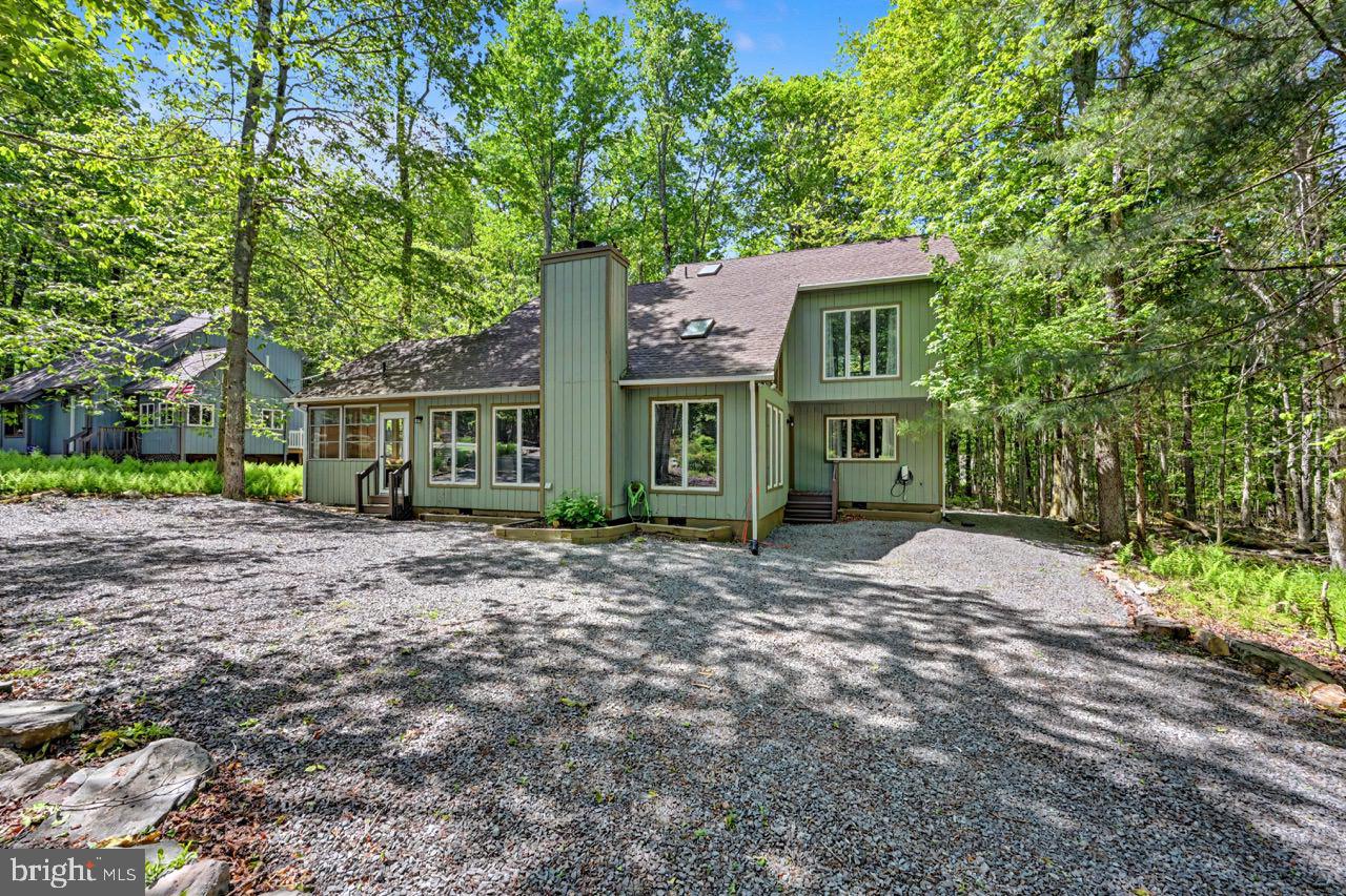 Welcome to 154 Moshannon Drive! Beautifully updated, well maintained, and ideally situated just steps from Minisink Pool, this 3-bedroom, 2-bath home is ready for its next owner. The interior features a renovated kitchen with granite countertops, stainless steel appliances, and ample workspace. Both bathrooms have been completely updated, while real hardwood flooring and new carpeting add warmth and character throughout the home. Additional improvements include a fully encapsulated crawlspace, providing added protection and efficiency. Outside, you'll find a spacious rear deck for entertaining, grilling, or simply enjoying the Pocono mountain air, along with a sun porch that offers extra space to relax in any season. Located in the highly desirable Arrowhead Lake community, owners enjoy access to three outdoor pools, multiple sandy beaches, playgrounds, lakes, and a full calendar of community activities and events throughout the year. Community sewer service provides added convenience, eliminating concerns often associated with private septic systems. Whether you're searching for a primary residence, vacation getaway, or short-term rental investment, this property offers the updates, amenities, and location that today's buyers are looking for.
