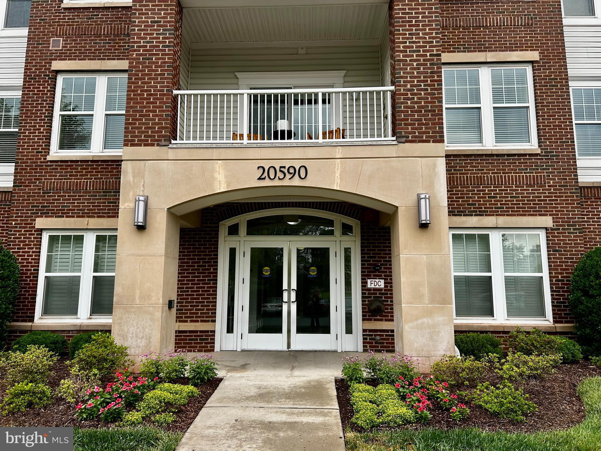 Fantastic opportunity to own in Potomac Green - Loudoun County's premiere active adult community! This beautiful Beaumont model condo offers 2 spacious bedroom 2 full bathroom over 1347 square feet of living space - PLUS there's a charming balcony backing to private woods, covered parking spot, AND extra storage unit! Gourmet kitchen features wood flooring, granite countertops, maple cabinets with under cabinet lighting, and stainless steel appliances (gas cooking!). Grab a quick bite at the breakfast bar or host meals in the formal dining room, with elegant crown and chair rail molding. Large living area has crown molding, and a slider door out to the balcony. Expansive primary bedroom, which offers custom walk-in closet, BONUS additional closet, and a large en-suite bathroom with double vanity, ceramic tile floor, and standalone shower with glass door and built-in seat. Spacious second bedroom would also make for an excellent home office, and the full guest bathroom has a tile floor and shower/tub combo. Recent updates to include new water heater, fresh paint, custom closet shelfs. The vibrant Potomac Green community wins awards for a reason - standout amenities, an array of social opportunities, and an ideal location. The gated neighborhood has a remodeled 26,000 square foot clubhouse, indoor and outdoor pools, tennis and pickleball courts, fitness center and indoor track, miles of trails, and even garden plots! Residents can participate in a dazzling variety of clubs, groups and activities - there truly is something for everyone. Enviable proximity to One Loudoun, the Loudoun County Senior Center, Inova Loudoun Hospital, as well as major routes of transportation. Pride of ownership!!
