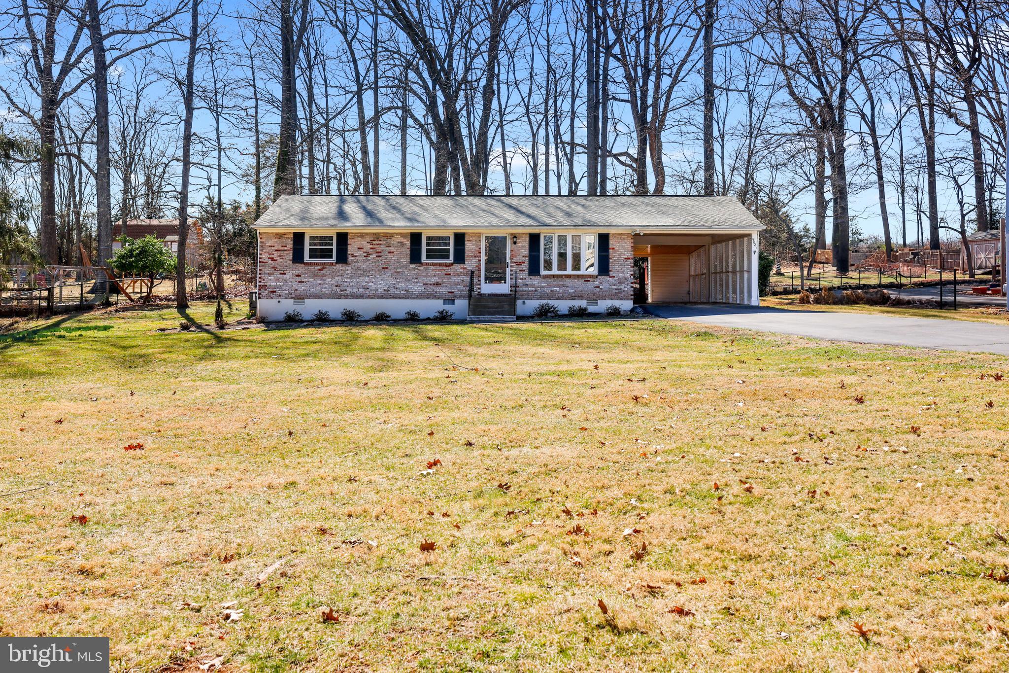 **Offer Deadline, Monday 3/17 at 12PM ET.** Welcome home to 5021 Dogwood Drive, a well-built and maintained brick rambler offering 3 bedrooms, 1.5 baths, and one-level living on a flat, nearly 1-acre lot. Located on a quiet, non-through street, this home provides the perfect blend of privacy and comfort. Step inside and fall in love with the warm, inviting spaces. The updated kitchen features updated cabinetry, granite counters and a stacked stone backsplash, perfect for cooking and entertaining. The family room’s vaulted knotty-pine ceiling and large picture window create a cozy yet open feel, showcasing wooded views. Just off the family room, step onto the spacious deck, ideal for relaxing or entertaining while enjoying the peaceful surroundings. This home has been thoughtfully updated and well cared for, including a new roof (2020), new HVAC - central heat + A/C with a digital programmable thermostat (2015), new water heater (2021), new well (2013), and newer windows for energy efficiency. The oversized carport fits two cars end-to-end, with a large driveway for additional parking. Located off Riley road on the DC side of Warrenton in the highly sought-after Kettle Run school pyramid, this home offers both tranquility and convenience. With unbeatable convenience, it's just a 12-minute drive to downtown Warrenton, 10 minutes to Wegmans, 7 minutes to Old Bust Head Brewery, and 10 minutes to The Winery at Sunset Ridge Farm. If you’ve been searching for a home that offers charm, modern updates, and a peaceful retreat, this is it.