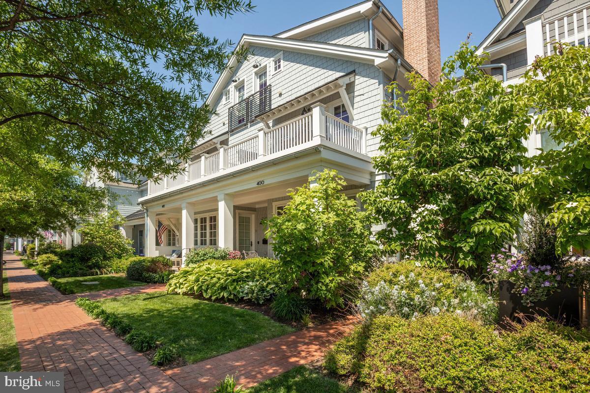 Embrace the ease of true coastal living in this beautifully appointed home, ideally situated just a short stroll from the waterfront and the bustling center of Downtown Annapolis. Blending classic seaside charm with refined finishes, this meticulously curated home features stunning interiors, where every detail reflects superior craftsmanship and thoughtful design. Rich hardwood flooring, custom moldings, and plantation shutters in the living room establish a sophisticated ambiance throughout. The formal living room, anchored by a gas fireplace, offers an inviting yet polished setting for both intimate evenings and gracious entertaining. At the heart of the home, the gourmet kitchen is impeccably appointed with professional-grade Thermador appliances, an expansive Silestone center island, and a custom-designed polished nickel pot rack by Ann Morris—a striking statement of artistry and function. Step out to the covered patio overlooking the thoughtfully designed gardens, creating a seamless transition between refined interiors and serene outdoor living. The primary suite is a sanctuary of comfort and privacy, featuring two substantial walk-in closets, a spa-inspired bath and a private balcony. A separate den on the primary suite level with its own balcony provides space for a study or a quiet reading room. The third level features two additional ensuite bedrooms both with vaulted ceilings, one offers a private balcony and the other a French balcony - both bathed in natural light and architectural character. Completing this exceptional offering is a detached two-car garage with unfinished storage above and the added exclusivity of private gated parking. The large unfinished lower level is perfect for extra storage! Perfectly positioned within walking distance to Downtown Annapolis’ acclaimed restaurants, boutiques, and cultural attractions, this home presents a rare opportunity to experience coastal living with grace, sophistication, and enduring style.