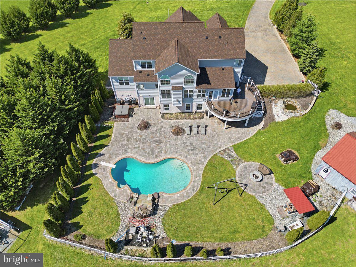 Exceptional luxury estate offering nearly 6,000 sq ft of refined living in the heart of Lovettsville. This elegant 6BR/5.5BA Colorado model by Khovnanian Homes seamlessly blends timeless design, modern upgrades, and resort-style outdoor living.

Designed for both grand entertaining and everyday comfort, the home features over 4,300 sq ft on the main and upper levels, complemented by a beautifully finished 1,600 sq ft lower level with a private bedroom and full bath—perfect for guests, extended stays, or a sophisticated in-law or au pair suite.

At the heart of the home, the chef’s kitchen showcases a recently updated gas cooktop and microwave, flowing effortlessly into expansive living and dining spaces filled with natural light. Thoughtful enhancements throughout include a new roof with transferable 30-year warranty, new whole-home water filtration system, and a highly efficient 3-zone HVAC system for optimal year-round comfort. Owned 500 gallon, underground propane tank. 

Step outside into your own private resort. The meticulously designed outdoor oasis features a spacious Trex deck, a stunning in-ground pool with waterfall, tranquil koi pond, wood-fired pizza oven, and an inviting fire pit—creating an unparalleled setting for entertaining or unwinding under the stars.

Additional highlights include a dedicated workshop and two storage sheds, offering exceptional flexibility for hobbies, projects, or additional storage needs.

A rare offering that combines space, sophistication, and an extraordinary outdoor lifestyle—this is luxury living at its finest.