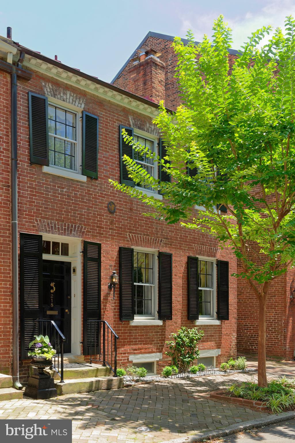 218 South Royal Street enjoys a storied provenance and prime location right in the heart of Old Town. Built in 1800, by Reuben Johnston, who built 214, 216 and 218 South Royal, the charming brick home sits on one of Alexandria s original town lots, 1 1/2 blocks off King Street, a commercial street since the 1800's.218 is the largest of the 3 houses and the only one that s semi-detached, now with parking on the south side. It is also one of the first thousand houses in Alexandria with running water! Back in the day, a stable was situated behind 218 and 216. Horses walked down the path between 218 and 220 (now a side garden/inner courtyard for 218 plus off-street parking) to access the stable in the rear.One of the early owners of 218, circa 1844, was William Wallace Adam, a silversmith. With its rectangular shape and 2 stories, the house exemplifies the Federal style of the 1820-1830's, but its dentil cornice along the roof line and transom ornamentation above the entry door are reflective of the Georgian period of architecture. Lovely flower boxes line the windows, graced by classic shutters. Many original details of this gem include an original front staircase, original floors throughout, original solid 6-panel entry doors and casings in the living and dining room,plus 2 original fireplace mantles in both rooms supported by reeded pilasters. Old meets new in the recently renovated eat-in kitchen with wood cabinetry, a furniture island, copper sink, and bow window facing the inner courtyard with fountain. Adjoining is a sunny family room with built-in wood cabinets flanking the raised fireplace, and a full bath. A small light-filled room with skylights and 3 windows beyond the family room, perfect as an office,overlooks the pool and plantings. Upstairs await 4 spacious bedrooms and 3 full baths. The master suite has a fireplace,window seat, his and her bathrooms, and separate newer private staircase to the first floor. Storage is very extensive for a historic home. Outdoors is delightful, with an L-shaped in-ground pool area with mature plantings, brick patio, and outdoor kitchen with natural gas line and a refrigerator for entertaining.  Fireplaces convey as is.