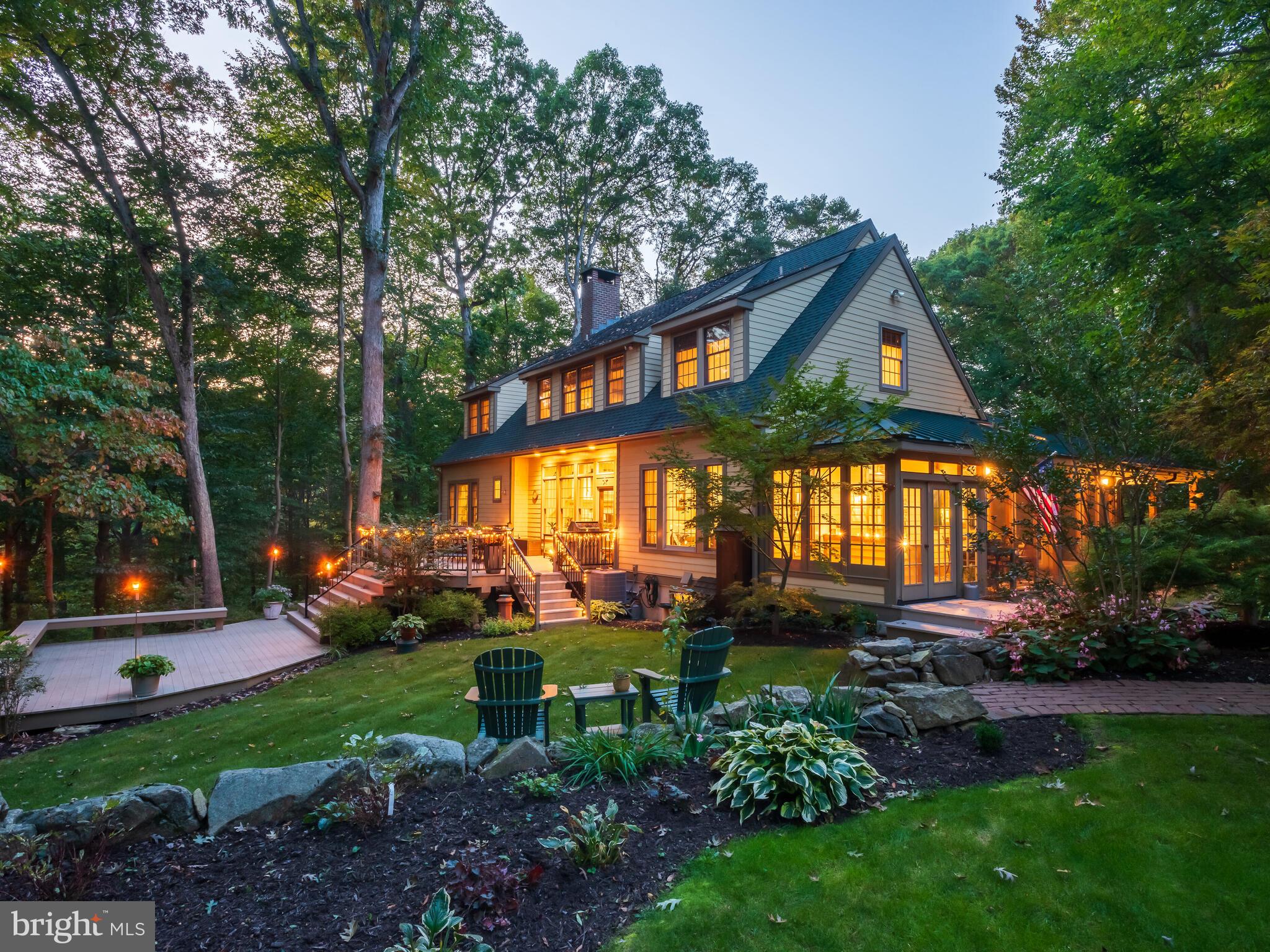 Searching for a slice of quiet rural living w/out sacrificing convenience? From passing the historic stone walls lining the entrance of the driveway, to the moment you drive up to this stunning Craftsman style Cape Cod, you are left in awe. Sitting atop a hill far back from the road, the mature trees & beautiful foliage mixed with historic Chester County charm steal your heart. As you approach the front of the home along the brick walkway, you cannot help but to admire the large covered wrap-around porch w/ multiple areas to enjoy your coffee or wine. Upon entry, the abundance of natural light, modern hardwood floors & open layout w/ 10’ ceilings set the stage for this custom-built home. Off the foyer you will find the spacious family room featuring a Rumford wood burning fireplace w/ arched brick surround & built-in niche for wood storage, built in shelving, large transom windows & a glass door leading to the multi-level back deck w/ gorgeous views of the property. Open to the FR is the very spacious eat-in kitchen creating the perfect space to entertain loved ones for dinner or summer parties of all sizes. The stunning kitchen features custom tall inset cabinets, quartzite countertops, paneled fridge & dishwasher, Thermador gas cooktop, wet bar w/ wine fridge & an expansive island w/ seating. The eat-in area includes views of the back yard & a side entry door leading to the screened in dining porch w/ a dry bar & mini fridge. Off the other side of the kitchen you will find the mudroom & laundry room conveniently located w/ a side entry door leading to the covered porch closest to the driveway. At the opposite end of the home, the luxurious first-floor primary suite is privately situated & includes a sitting room lined w/ windows (allowing for gorgeous views from your bed in all four seasons) w/ a gas stove & access to a balcony & a private screened in porch. The spacious ensuite bathroom has a dual sink vanity, tiled walk-in shower, tub & a walk-in closet. Completing the first floor is a privately located powder room off the foyer. Venture upstairs to the oversized hallway landing where you will find 3 addt’l spacious bedrooms w/ ample closet space (one w/French doors and including stairs to the walk-up attic). A shared hallway bathroom, cedar closet, linen closet & dormer closets complete this level. The finished walk-out basement has French doors to the lower-level paver patio for indoor/outdoor entertaining. Inside is a family room w/ gas stove, plus addt’l space for a game room, playroom, etc. A private room w/ a closet is situated next to a full bathroom at one end of the bsmt. Off the FR is a workout room & an unfinished storage room w/ shelving. An addt’l separate office w/ its own side entry has steps up to the screened in porch nearest the driveway for easy coming/going. The property includes a heated detached garage (40x40) w/ an oversized 4-car bay on one side, & the other side is a drive-through shop w/ 14’ ceilings, 11,000 lb capacity lift, room for 2 vehicles w/ a 3rd vehicle on the lift, as well as half bath, separate 200amp meter & septic tank. Above is add’tl living
space (800sqft) including a full kitchen & bathroom. This gorgeous property includes plenty of yard space, perennial gardens, a garden shed, & a firepit w/ bench seating & boulders – perfect for hanging out on the crisp nights ahead! The bottom of the driveway splits & includes run-in shed w/ tack room on the lower section of the property. Whole house automatic generator. New Bosch HVAC system installed in 2023 with new thermostat in 2026. Newer roof on main house. New tankless water heater 2023. This home is the epitome of classic elegance & quiet living w/out being far from restaurants, shopping, Schools, Township Park, Marsh & French Creek State Parks, & major routes (PA Turnpike, 322, 82). Prepare to fall in love!