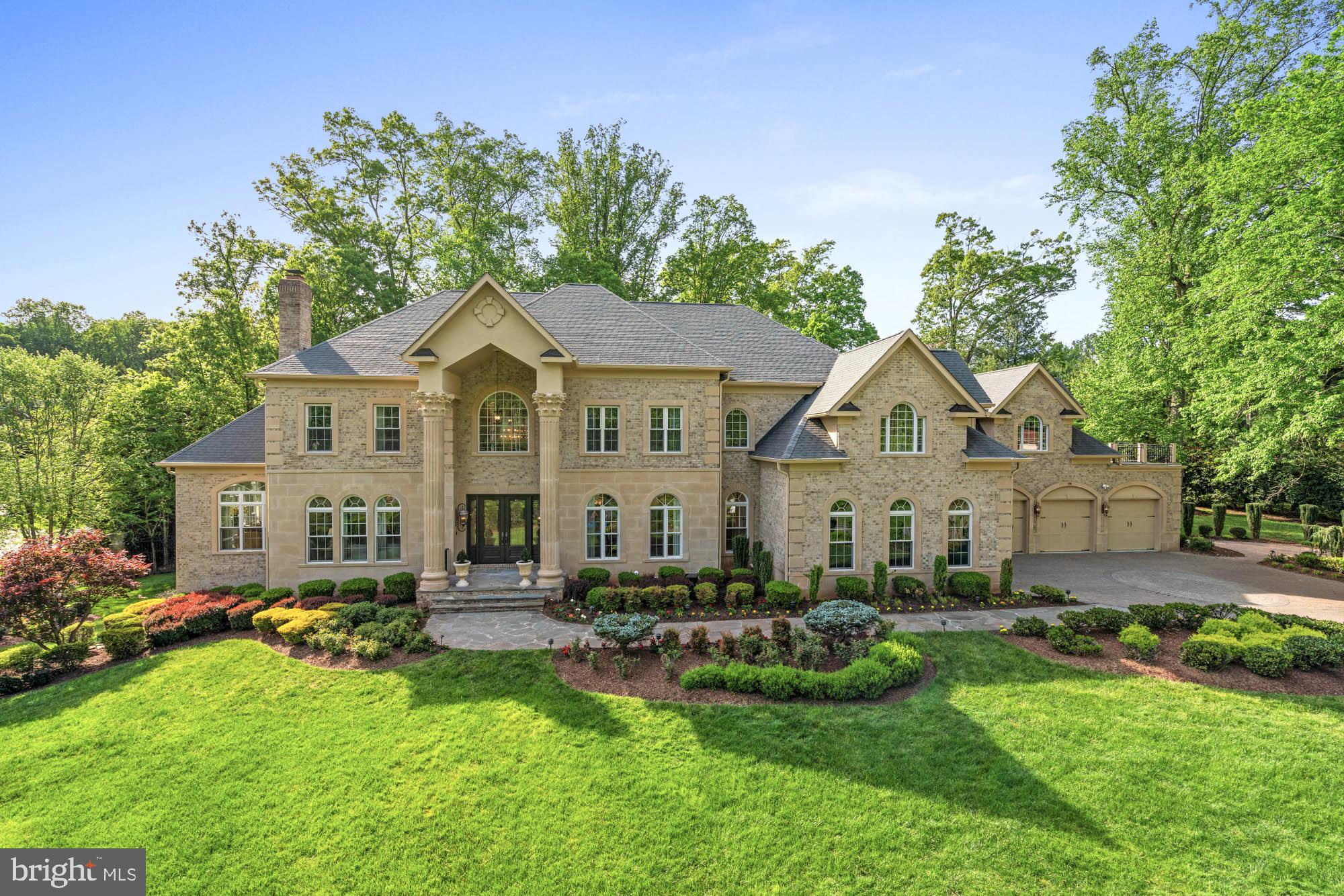 Timeless elegance, masterful design, and a Great Falls Best address on just over one acre create a dazzling first impression. As you walk through the front doors, you are greeted by a double-height foyer featuring a curved, bifurcated staircase, elegant iron railings, and marble flooring. The thoughtfully executed floor plan ensures an effortless flow from room to room. The formal living room is highlighted by a gas fireplace and receives beautiful morning sunlight. The dining room also features a fireplace and is serviced by a butler’s pantry. An inviting sunroom, flooded with natural light, is designed with sunflower-inspired decor and includes a walk-out to a sprawling two-level deck. A cozy study, tucked away just off the foyer, is designed for versatility, serving as a functional office or a serene environment for quiet reading and intimate gatherings.
The spacious great room features three distinct areas: an entertaining area with a large television, a vibrant sitting room that opens to the home's second expansive deck, and a gourmet kitchen, ideal for the home chef. This kitchen is complete with two large islands, rich designer cabinetry, and top-of-the-line appliances, including a six-burner Wolf range, along with casual countertop dining for relaxed meals. The sophisticated second level boasts five ensuite bedrooms, highlighted by a sweeping primary suite featuring a sitting room and a covered private balcony. The primary bathroom rivals a five-star spa, with a soaking tub and an oversized shower. This impressive layout continues on the lower level, showcasing an open entertaining area complete with a wet bar that doubles as a kitchenette. Enjoy a billiards area, home theater, golf simulator room, gym, and another full bedroom and bathroom. The rear grounds, perfect for outdoor living, feature extensive hardscape, a covered seating area, a pond, outdoor cooking, and a lush lawn, all enveloped by mature landscaping for ultimate privacy. This home and bodies the pinnacle of luxury living, seamlessly  combining an impressive array of modern amenities with an ideal location for an unparalleled family lifestyle.