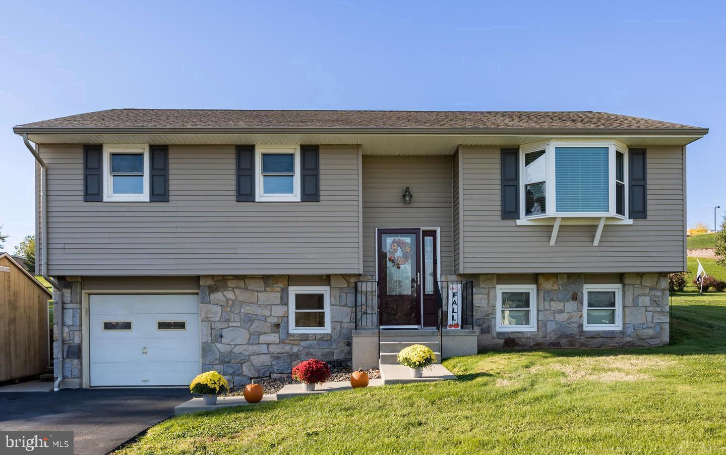 Welcome home to this beautifully updated split-level in the heart of Birdsboro. An extra-wide driveway provides plenty of parking and leads to a large storage shed for additional storage. Inside, you'll find bamboo flooring throughout the main level, updated trim, doors, and fixtures, creating a bright and inviting feel. The sun-filled living room features a bay window, while the dining area offers sliding door access to the backyard. The spacious kitchen includes solid wood cabinetry, solid-surface countertops, subway tile backsplash, stainless steel appliances, a 5-burner gas range, breakfast bar seating, and additional custom storage. Down the hall are an updated full bath, generous closet space, and the primary suite with double closets and a private powder room. 
Just look out back from the Rear Patio and see an amazing private view - 
Enjoy the peace and privacy of country living while still being within easy reach of Reading, King of Prussia, and Philadelphia. Surrounded by the natural beauty of the Hopewell Big Woods and nearby French Creek State Park, the area offers a true outdoor lifestyle with hiking, biking, fishing, and scenic views right outside your door