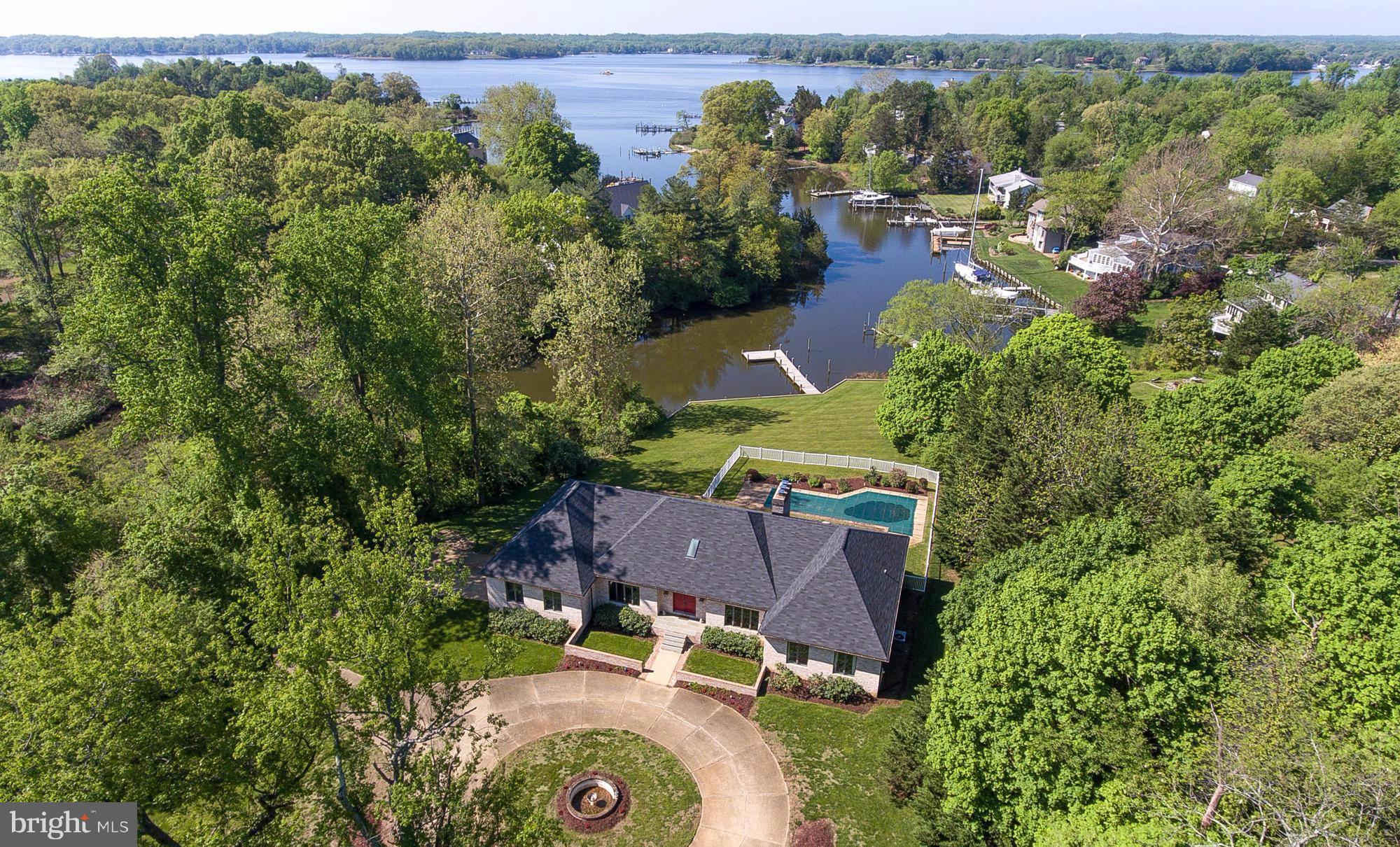 Rarely offered 2+ Waterfront Acres in the premier Wild Rose Shores community, just minutes to Downtown Annapolis. Meticulously cared for one-level living with over 128' of water frontage.  Expansive water views  & beautiful waterside pool. LG 3000sf+ unfinished basement w/ fireplace & high ceilings. Elegant circular drive, 2-car garage, new private pier & 4' MLW. Being offered As-Is.