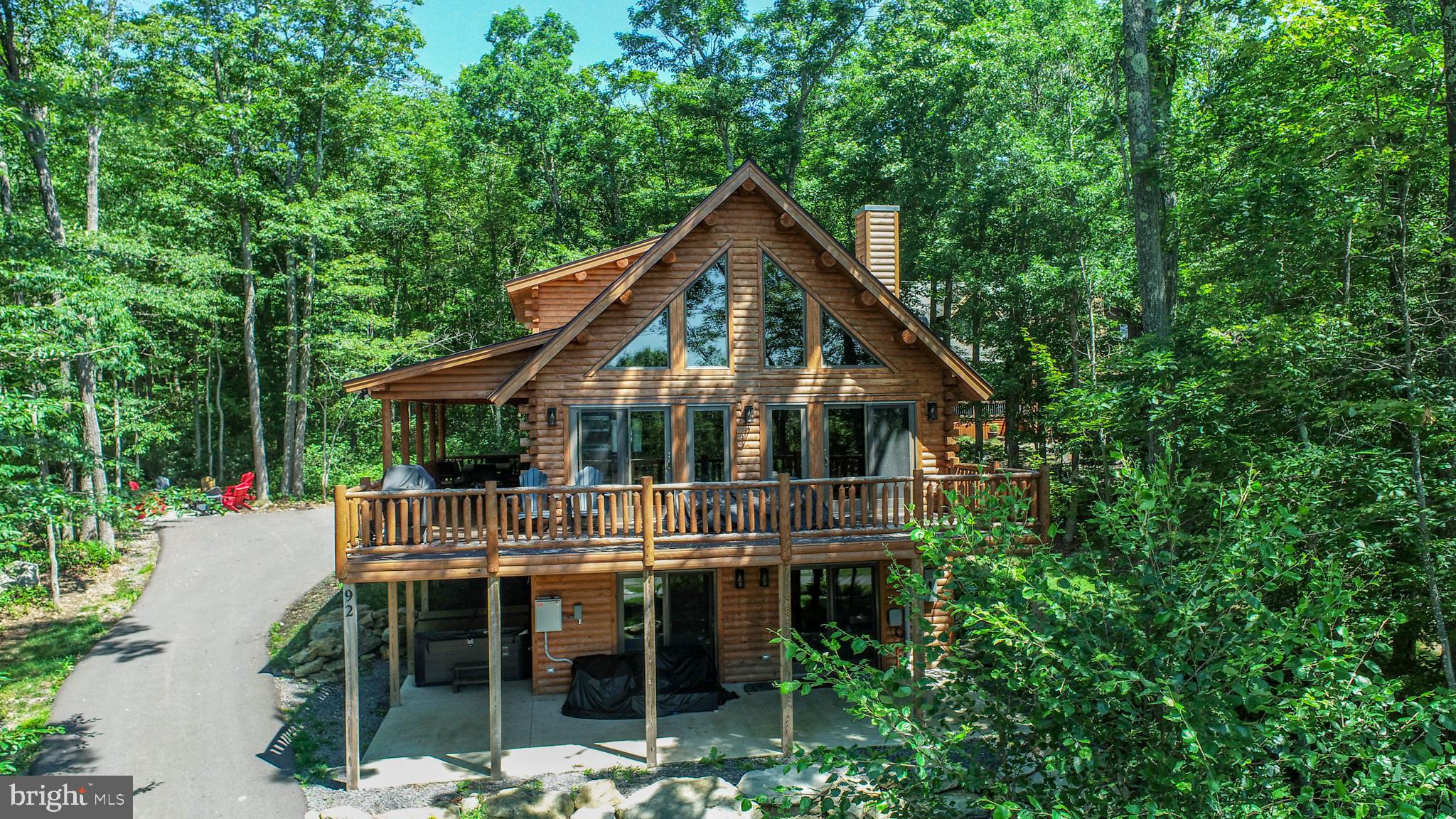 Mountain Log Home Retreat in Deep Creek Highlands
Experience the perfect blend of rustic elegance and mountain comfort in this stunning 5-bedroom custom Northern White Cedar log home. Spanning three finished levels, this beautifully crafted retreat showcases soaring purlin-beamed cathedral ceilings that create a warm, open atmosphere filled with natural character. Nestled in a private wooded setting, this home offers the peaceful mountain lifestyle you've been searching for while providing access to the exceptional Deep Creek Highlands amenities, including lake access. Offered fully furnished, this turnkey property is ready for immediate enjoyment as a primary residence, vacation home, or investment opportunity. Relax after a day on the lake or slopes in the private hot tub, surrounded by the tranquility of nature.
Additional features include public water and sewer, providing the convenience of public utilities with the charm of a secluded mountain retreat.