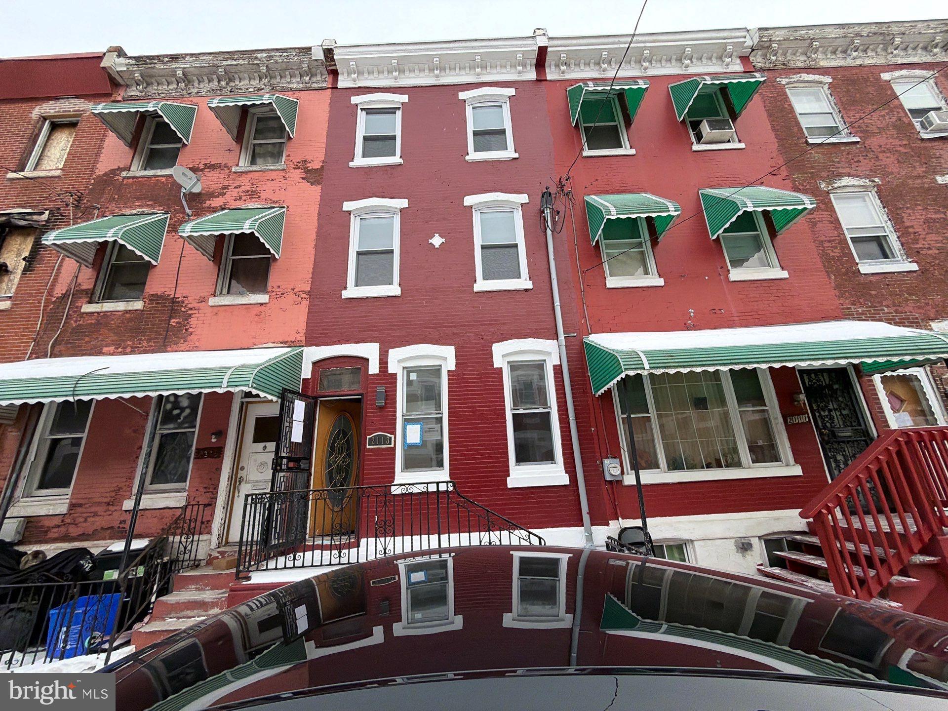 Situated just minutes from Temple University in Philadelphia’s rapidly evolving 19121 corridor, this three-story property at 2133 N. Woodstock St. has been thoughtfully converted into a triplex and offers strong potential for both owner-occupants and investors. A shared entry provides access to three separate units, including a first-floor one-bedroom, one-bath apartment with access to the full basement and rear yard, a second-floor one-bedroom, one-bath unit, and a spacious third-floor layout that can function as either a two-bedroom, one-bath apartment or a one-bedroom with an additional living area. While some finishing touches remain, the layout and structure are already in place, making this an excellent opportunity to add value and customize to your vision. The property is zoned RSA5, and buyers are encouraged to confirm permitted use as a triplex. Conveniently located near public transportation, neighborhood shopping and dining, major commuter routes, and Temple University’s campus, this property is ideal for those looking to live in one unit while renting the others or expand a growing rental portfolio.