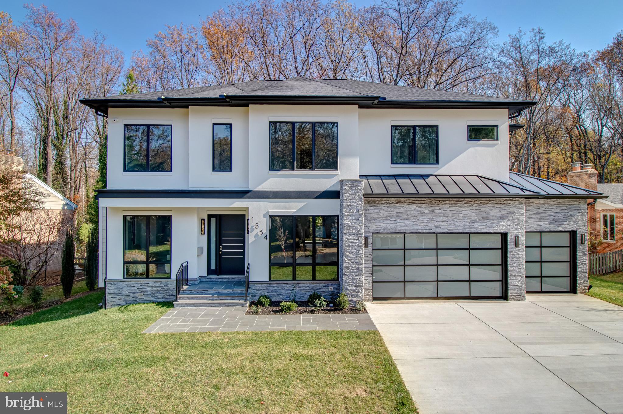This spectacular new build from Kul Homes is intelligently-designed with 6 bedrooms, 6 ½ baths and 7,400 sq ft of living space.  The home is expertly sited on a premium 0.34 acre lot backing to woods.   The home features a 3-car garage, 10’ ceilings on main and upper levels, oversized windows, upgraded crown molding and trim, numerous custom built-ins, designer light fixtures, and wide-plank white oak engineered hardwoods.

Entering into the spacious foyer of this elevator-ready home with main level ensuite bedroom, reveals an open floor plan featuring a light-filled family room with a gas fireplace, a home office/study, and an elegant dining area which connects to the gourmet kitchen through a well-appointed butler’s pantry. The spacious kitchen with inset cabinetry, Thermador appliances,  including built-in coffee maker, has an oversized center island with second sink, second dishwasher and space for 4 stools, as well as a large breakfast area. Direct access to the screened-in porch with a media-ready fireplace that connects to a large deck, with stairs to the lower slate patio. 

The upper level features 4 ensuite bedrooms, a well-designed laundry room and a flex room, ideal for a home office, playroom, study or exercise studio. The spacious primary suite includes a sitting area with a gas fireplace, beverage station and access to the large balcony overlooking the tree-lined backyard. Just past the dual walk-in closets with floor-to-ceiling custom cabinetry, the luxurious primary bath offers a walk-in steam shower, freestanding tub and dual sink vanity. The lower level has an open rec room with a gas fireplace, wet bar,  media room, exercise room, and a guest room with an ensuite bath.

McLean High School pyramid; minutes to downtown McLean and Tysons, with easy access to major commuter routes.