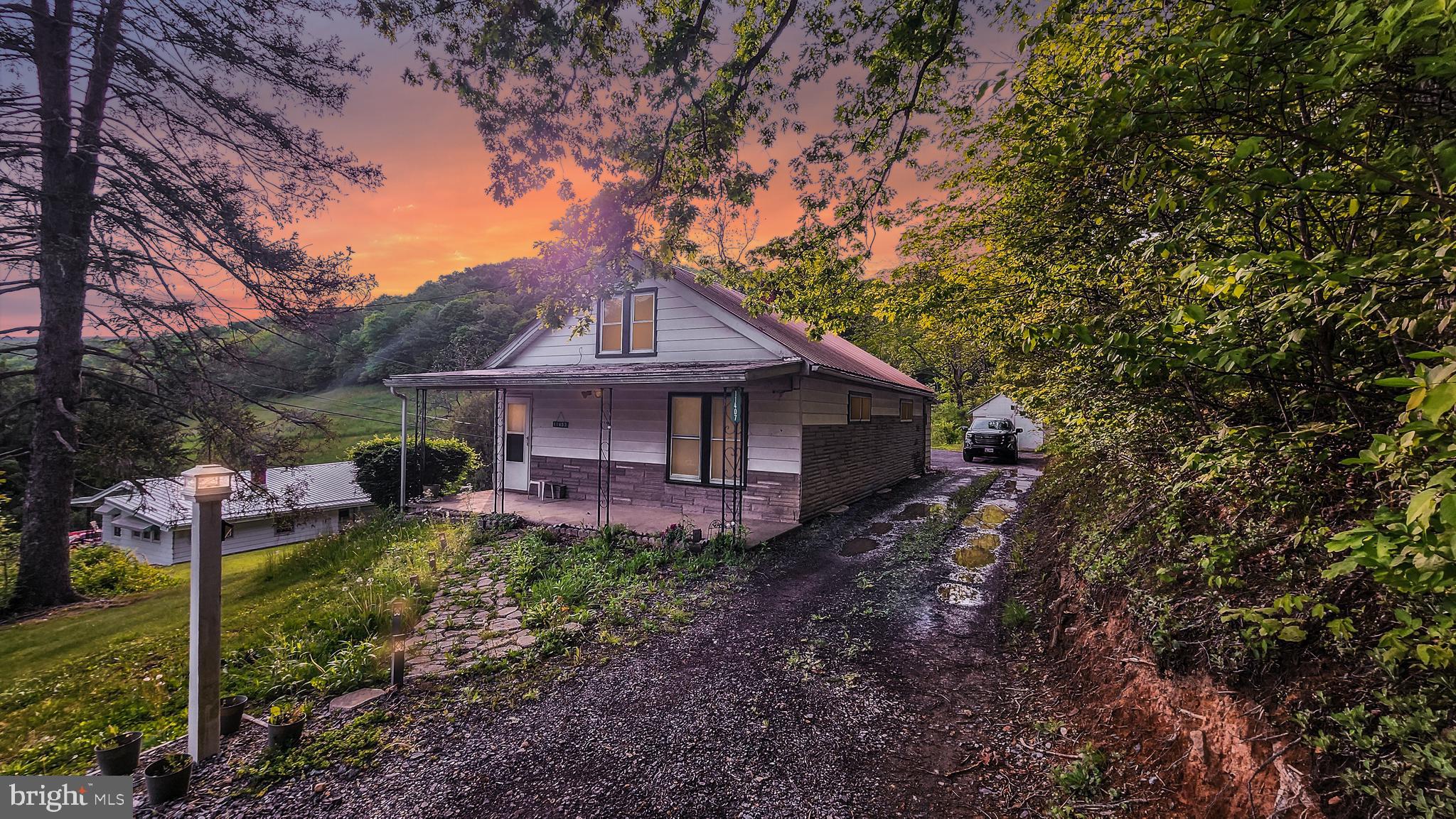 Situated on two separate, non-connecting parcels totaling a generous 1.38 acres, this property offers an opportunity for serene countryside living while maintaining proximity to Cumberland, the excitement of the Rocky Gap Casino and Resort, and the allure of several nearby campgrounds. 2 possible 3-bedroom, 1 full bath with a huge basement home that epitomizes one-level living, set amidst the tranquil beauty of nature. 

As you step into this charming residence, you're greeted by the timeless elegance of wood floors that adorn the living spaces. The cozy living room is bathed in natural light, creating a welcoming atmosphere for relaxation and gatherings. The well-appointed kitchen, though sporting a dated atmosphere, offers functionality and space for culinary exploration.

Two spacious bedrooms provide peaceful retreats for a restful night's sleep, and the full bath ensures convenience for all occupants.

Storage is abundant with a detached garage, perfect for protecting your vehicles and outdoor gear. Additionally, an unfinished walk-up attic stands ready to accommodate your storage needs, keeping your possessions organized and easily accessible.

Investors will appreciate the property's strong rental history, making it a valuable asset for generating rental income. The appeal of this location, with its proximity to Cumberland, the Rocky Gap Casino and Resort, and multiple campgrounds, guarantees a consistent pool of potential tenants.

This unique property is equipped with oil heat to keep you cozy during the winter months and high-speed broadband internet to keep you connected in today's digital age. The property is serviced by spring water and public sewer, ensuring convenience and reliability in your everyday living.

While the interior exudes a dated atmosphere, it provides an excellent opportunity for renovation and personalization. Transform this space into your dream home, blending modern comforts with the charm of the past.

In summary, this 2-bedroom, 1 full bath home offers a serene escape with a touch of nostalgia. With wood floors, a detached garage, and an unfinished walk-up attic, it provides the space and potential for your storage needs. Its proximity to Cumberland, the Rocky Gap Casino and Resort, and various campgrounds offers a unique lifestyle blending rural tranquility with city conveniences. Embrace the opportunity to revitalize this property and make it your own. Contact us today to explore the possibilities that await you within these walls.