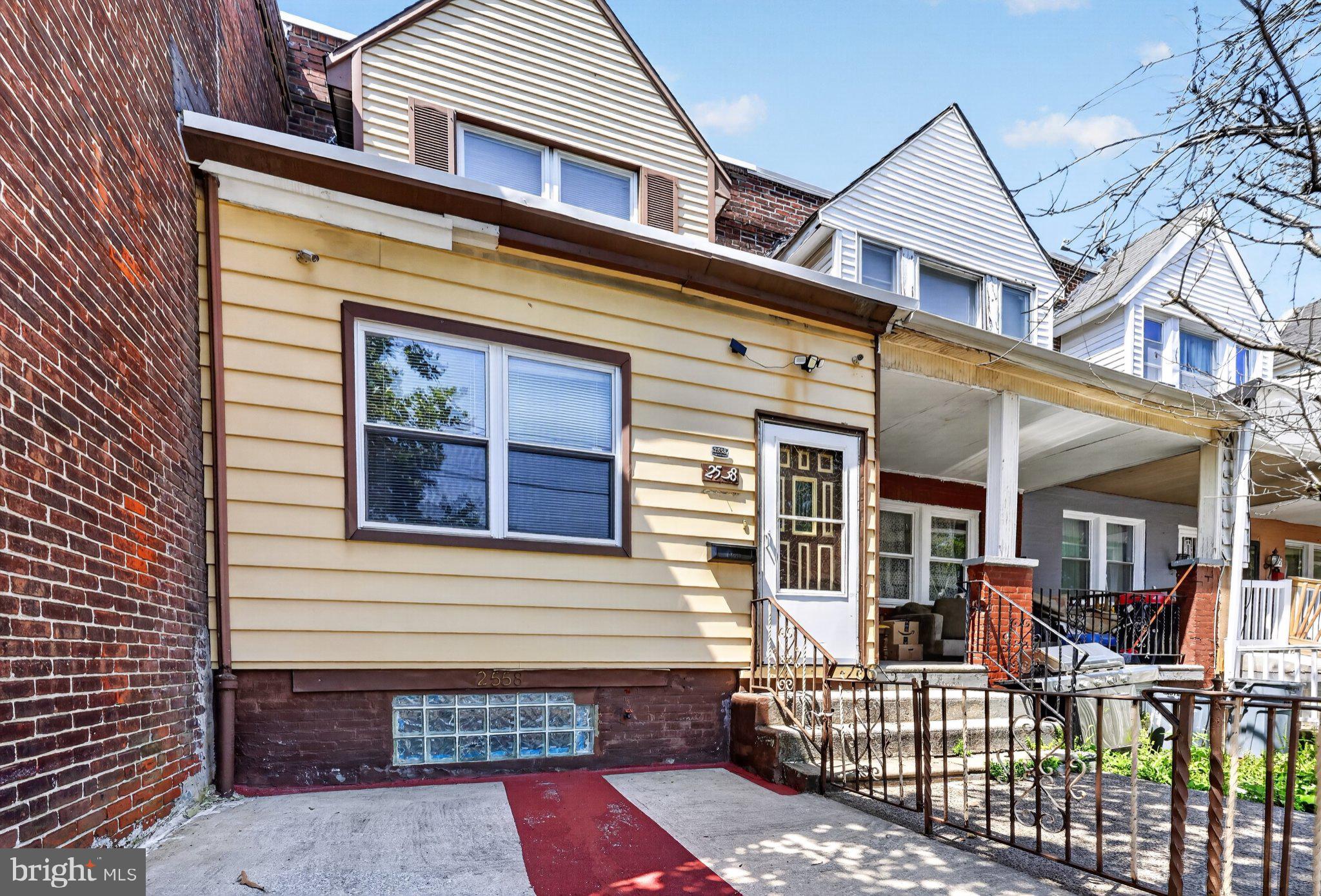 Nestled in the charming Paschall neighborhood, this exquisiteraditio nal townhouse offers a perfect blend of classic elegance and modern comfort.  This thoughtfully designed living space invites you to experience a lifestyle of warmth and sophistication. Step inside to discover a welcoming interior that features plush carpeting in the enclosed front porch with lots of natural lighting and rich wood floors throughout. The traditional floor plan seamlessly connects the living and dining areas, making it ideal for both intimate gatherings and entertaining guests. Natural light pours in through well-placed windows, enhancing the home's cozy ambiance. The heart of the home is the well-appointed dining area, perfect for enjoying meals with loved ones or hosting dinner parties. The bathroom features a classic tub and shower combination, providing a serene retreat for relaxation after a long day. This residence boasts three spacious bedrooms, each offering a tranquil haven for rest and rejuvenation. The layout ensures privacy while maintaining a sense of togetherness, making it a perfect sanctuary for those seeking comfort and style. The partially finished basement adds valuable space for a home office, gym, or play area, with walkout stairs leading to the rear patio, enhancing the home's functionality. The outdoor space, though compact, offers potential for a charming garden or patio area, perfect for enjoying the fresh air. Conveniently located less than 15 minutes from the airport, 25 minutes to Center City, 10 minutes to Bartram Gardens and within a 2 minute walk to public transportation, this home provides easy access to the vibrant city life while maintaining a peaceful neighborhood feel. On-street parking ensures that you and your guests will always have a place to park. Experience the allure of living in a home that combines timeless architecture with modern conveniences. This property is not just a house; it's a place where memories are made, and a lifestyle of comfort and elegance awaits. Embrace the opportunity to call this beautiful townhouse your home, where every detail has been crafted for your enjoyment and peace of mind.