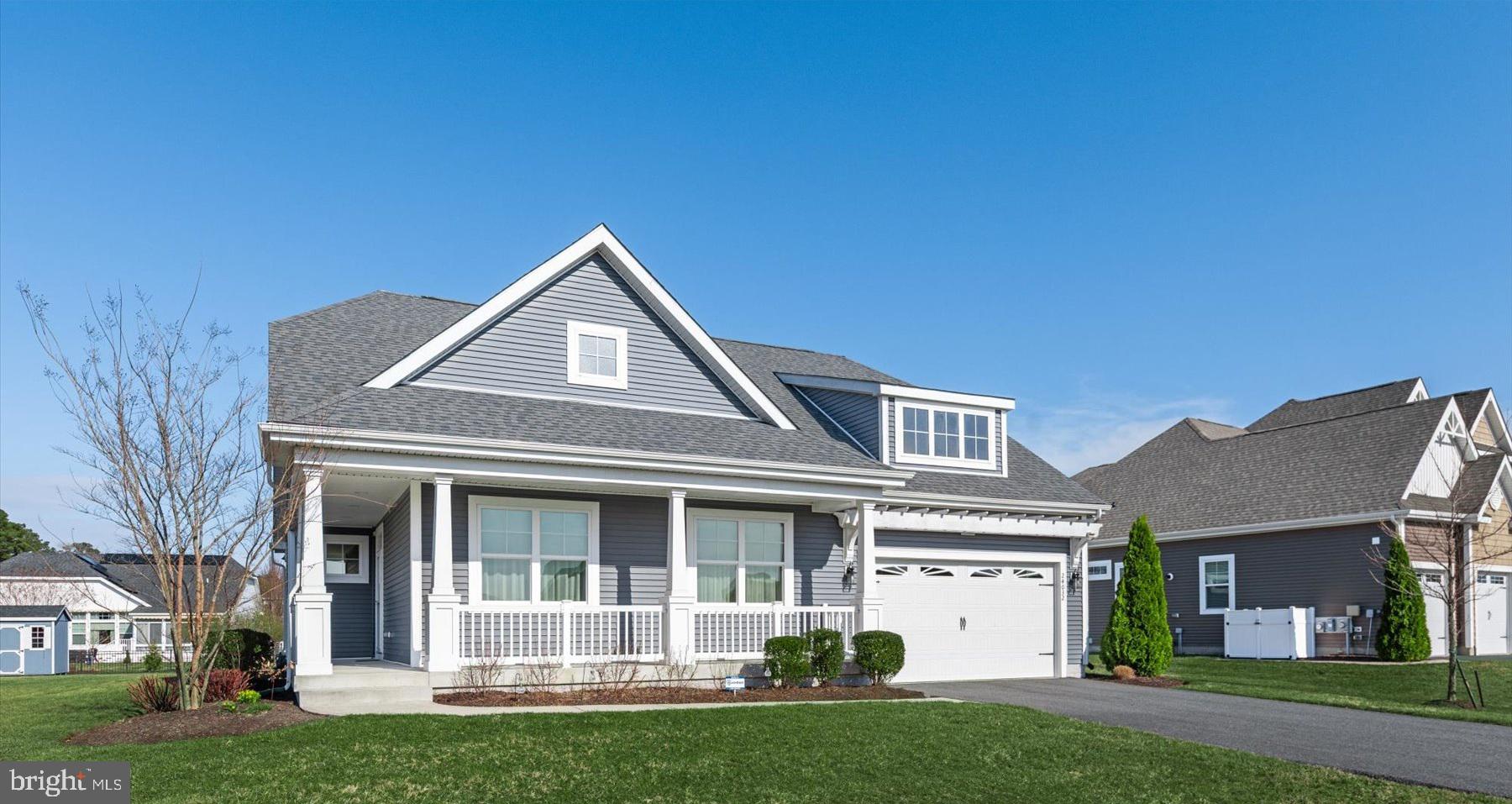 Welcome to this light filled 3-bedroom, 2 bath Schell Brothers home located in the premier 55+ community of Independence. This home is designed for people who value efficiency, and low‑maintenance living — every space is intentional. From the moment you arrive, the wraparound porch with its inviting side entry sets the tone for the comfort and charm found throughout. Step inside the bright foyer and immediately feel at home. Sunlight pours through the windows, highlighting the contemporary color palette, dark hardwood floors, white cabinetry, and grey granite countertops that define the main living spaces. The open layout creates an effortless flow ideal for everyday living and entertaining. The spacious primary suite is tucked privately to the rear of the home and features two walk-in closets and a cheerful, well-appointed bathroom. At the front of the home, two additional nicely sized bedrooms and a full hall bath offer comfort for guests or flexible space for hobbies and work. Enjoy morning coffee or evening breezes on the screened in porch, overlooking the large, oversized lot. If you want resort-style living, look no further. Life at Independence is all about connection, wellness, and fun. The 24,000 sq. ft. clubhouse is the heart of the community, offering an unmatched array of amenities including indoor and outdoor pools, locker rooms with showers, fitness center & yoga room, a library, a ballroom, a billiards & card room, and a bar/lounge area.  Additional outdoor amenities include tennis & pickleball courts, walking trails, community gardens and beautiful open spaces. Stay active with clubs, classes & activities like Tai Chi, Hatha & chair Yoga, a variety of aerobics, water fitness class, and dance till your hearts content with line dancing, swing and ballroom dancing. Connect with neighbors through the book club, theatre club, weekly happy hours, tea socials and special dinners & events. Enjoy community wide favorites like the annual yard sale, Spring carnival & egg hunt, and cornhole tournaments. The location is just unbeatable! Independence is perfectly situated—just a quick hop to grocery stores, restaurants, services, and the saltwater of the Rehoboth Bay and Indian River. You’re only 20 minutes to Rehoboth and Lewes beaches, making coastal living effortless.  Live Fully. Explore Freely. Enjoy Again. This home offers not only comfort and style, but a lifestyle filled with opportunities to learn, move, connect, and rediscover the things you love.
