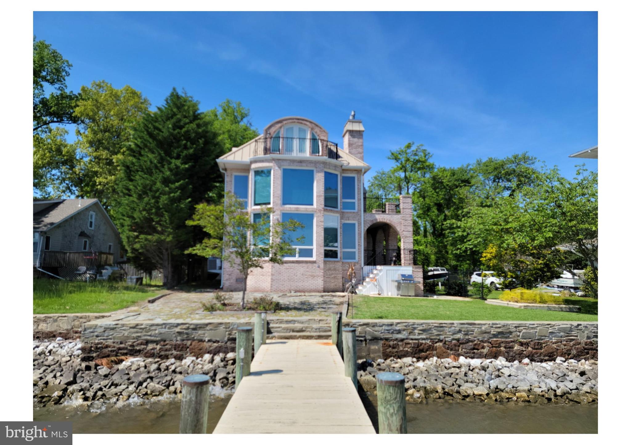 A MUST SEE multimillion dollar view from the first, second and third floor. Enjoy waterfront living at its finest. Open concept first floor. Full second floor private primary bedroom ensuite with soaking /jetted tub for relaxing . Want separation from family or guest. 3rd floor sleeping quarters contains 2 more bedrooms and full bath. Move in before the crowds know this one is available. Rare Opportunity kind of property.  Home has full brick exterior, wood floors, kitchen updates, gas stove. 2 gas fireplaces, new HVAC for the 3rd level, and a concrete stamped driveway. Soaring high ceiling, 2 levels of balconies, wrap around decks.  Super entertainment location inside and out.  Private pier with boat lift and kayak lift.