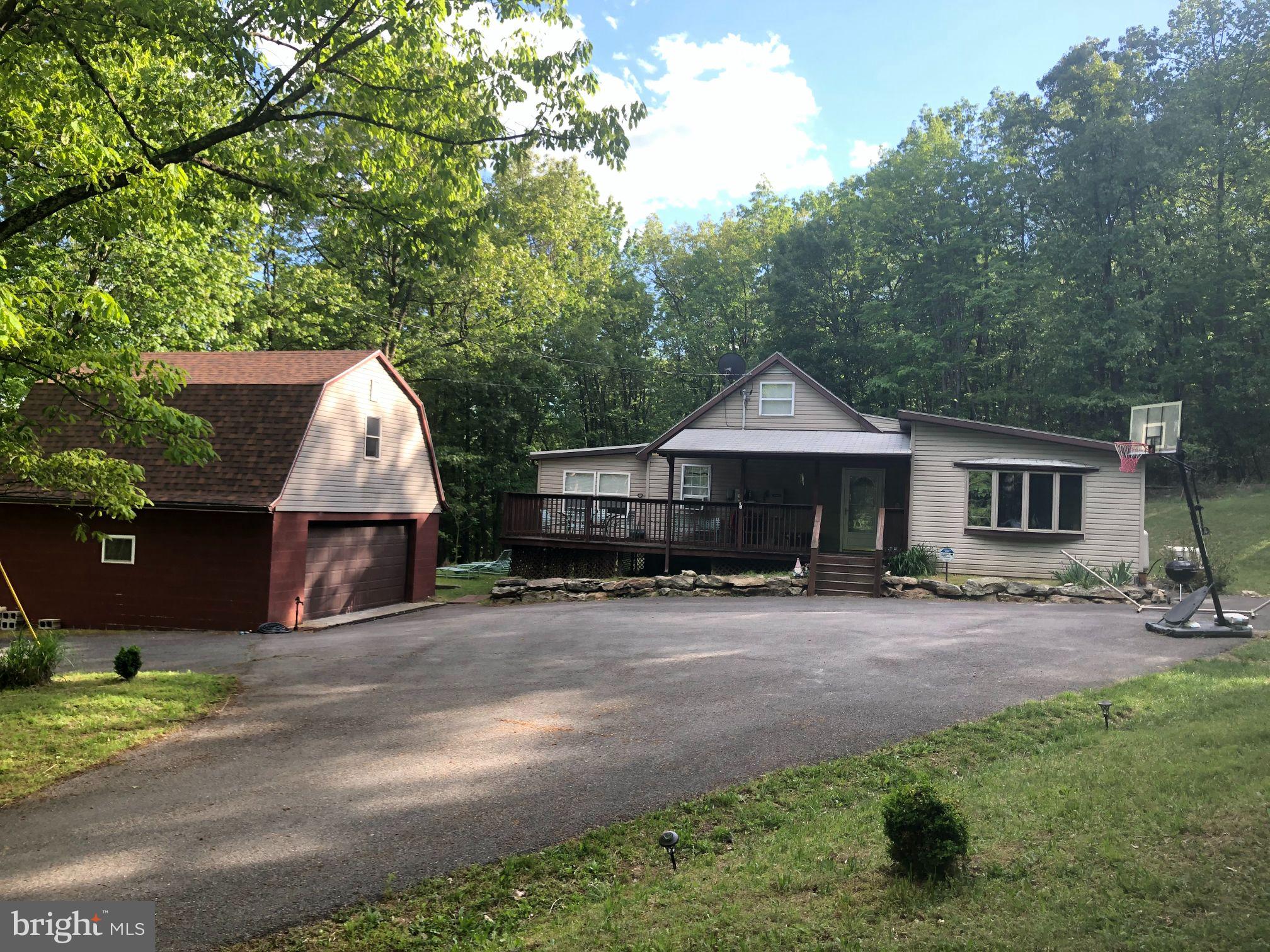 Check out this amazing cottage located in the serene mountains of WV!  Surround yourself with the peace and privacy of nature on 12 secluded acres, no neighbors in sight! The cottage sits on a bit over 5 acres with an additional lot included with this sale which has a bit over 6 more acres! The cottage offers 2 bedrooms with an additional sun room which can be added sleeping space if needed or a great place for office space. There is also a large garage with a finished bonus room above.  Outdoors you'll find a large yard, views, and plenty of woods to explore! This cottage is an active successful vacation rental as well.

All offers must be submitted by 5pm Friday 4/1/2022
