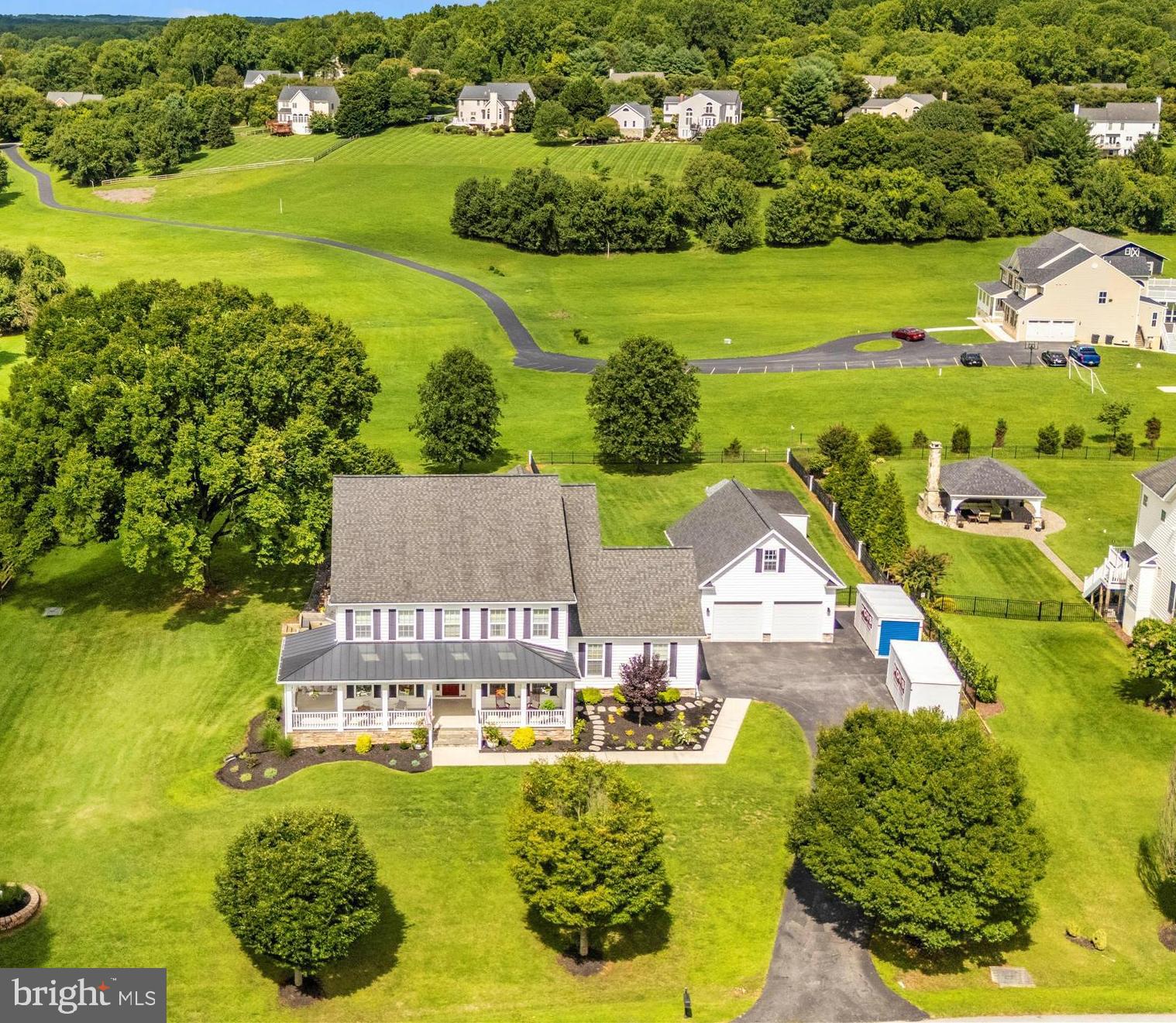 This stunning custom-built home offers a serene retreat on over an acre of beautifully landscaped land. The property features more than 6000 square feet of living space to include an In-law suite on the main level, with separate entrance, private laundry, and private deck. Perfect
for multi-generational living or accommodating guests. The spacious well equipped kitchen and open floorplan are an entertainer’s dream, with integrated speakers throughout the home andoutside, providing the perfect ambiance for any occasion. Step outside onto the sprawling deck
to enjoy the extensive hardscaping, partially fenced yard, and breathtaking views of the surrounding countryside. The private porch off the primary bedroom is a tranquil spot to start or end your day. You will be treated to the calming sounds of morning nature, and striking evening
sunsets from either spot. The heated, oversized garage offers a convenient storage loft, an EV hook up, plenty of space for parking and room for a workshop. The home is also equipped with a buried, owned, 1000 gallon propane tank and whole home generator. Tucked away in a quiet
neighborhood, with the school bus stop at the bottom of the hill, this home is the perfect blend of privacy and convenience. While you’ll enjoy the peace and tranquility of its secluded setting, you're still just minutes away from all the amenities that Maple Lawn has to offer. Baltimore,
Annapolis, Washington DC, Rockville, Alexandria, and Frederick are all within an hours drive. Whether it’s shopping, dining, or community activities, everything you need is within easy reach, allowing you to enjoy the best of both worlds—serene living with the benefits of a well-connected location.