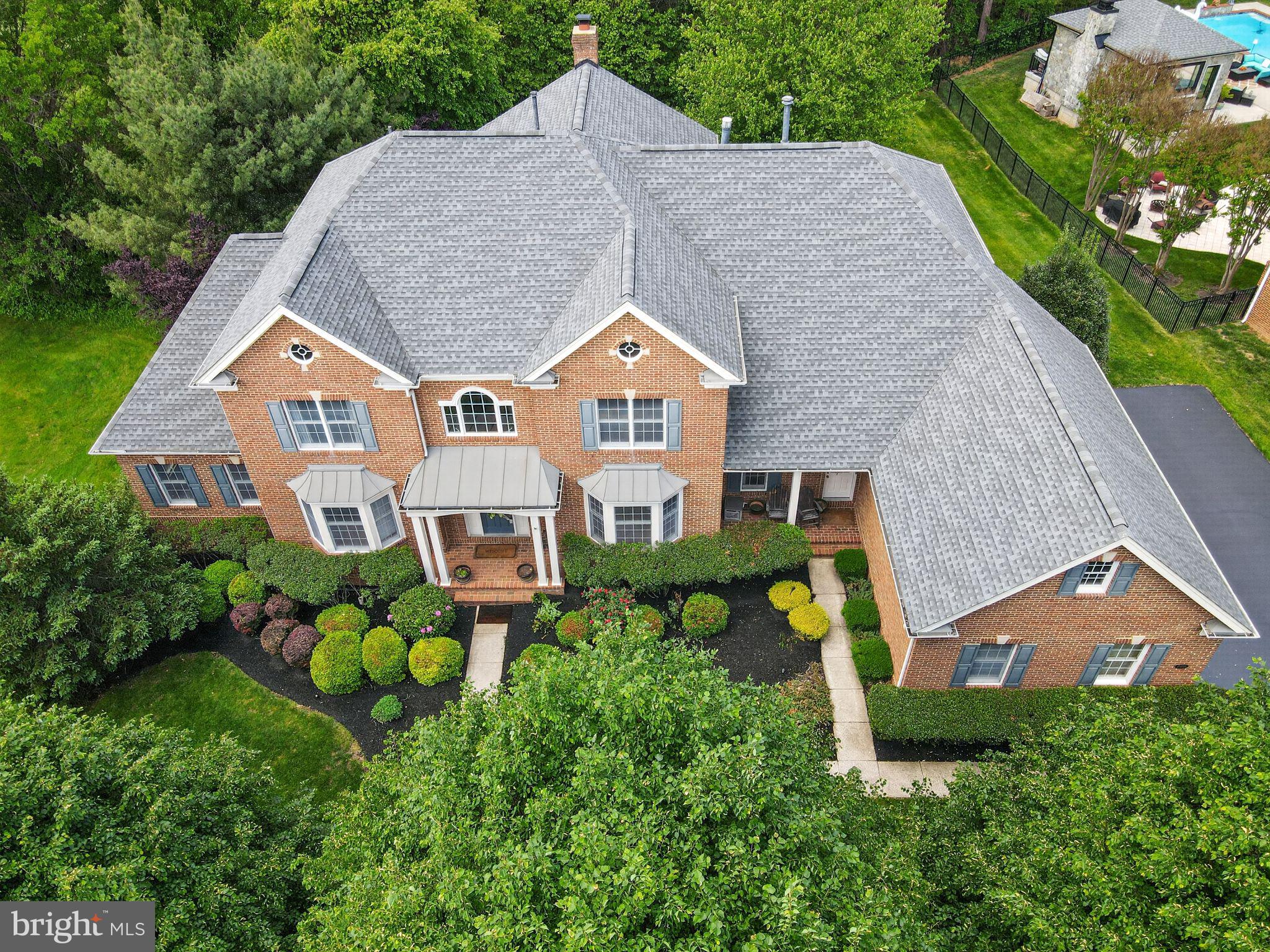 This home is located in Northern Virginia's Premier Gated community, the prestigious Dominion Valley Country Club, Discover an exquisite lifestyle in this stunning 4-sided brick colonial home adjacent to the 7th hole tee box on the Arnold Palmer signature golf course. Spanning an impressive 7,173 square feet, this home is designed for both entertaining and everyday living, featuring five spacious bedrooms and five and a half elegantly appointed bathrooms. As you step inside, you are greeted by an inviting foyer adorned with crown moldings and rich wood floors that flow seamlessly throughout the main level. The open floor plan is accentuated by an abundance of natural light, creating a warm and welcoming atmosphere. The gourmet kitchen is a chef's dream, equipped with stainless steel appliances, including a double wall oven and a cooktop, complemented by a butler's pantry for effortless entertaining. The breakfast area invites casual dining, while the formal dining room sets the stage for more intimate gatherings. Retreat to the luxurious primary suite, featuring a sitting room with gas fireplace, a walk-in closet and a spa-like bathroom complete with a jetted tub, perfect for unwinding after a long day. In addition, the primary bathroom features a rarely seen two private water closets. (toilets) Additional interior highlights include a cozy bar area, exercise room, two laundry spaces, a resort like walk in shower and bathroom, hardwood floors all 3 levels, additional stairway for convenience between main level and bedroom floor, and recessed lighting that enhances the home's sophisticated ambiance.  Step outside to discover the beautifully landscaped exterior, complete with a lawn sprinkler system that ensures your outdoor space remains lush and vibrant. The community amenities are unparalleled, offering access to a stunning golf course, multiple pools (both indoor and outdoor), tennis and pickleball courts, and a state-of-the-art fitness center. Enjoy leisurely afternoons at the picnic area or take a stroll along the scenic bike trails that wind through the community. Parking is a breeze with a side-entry 3 car garage and ample driveway space for guests. The property is situated on a generous 0.41-acre lot, providing plenty of room for outdoor activities and gatherings. This home is not just a residence; it's a lifestyle. Experience the perfect blend of luxury, comfort, and community in this exceptional property, where every detail has been thoughtfully curated to create a sanctuary, you will be proud to call home.