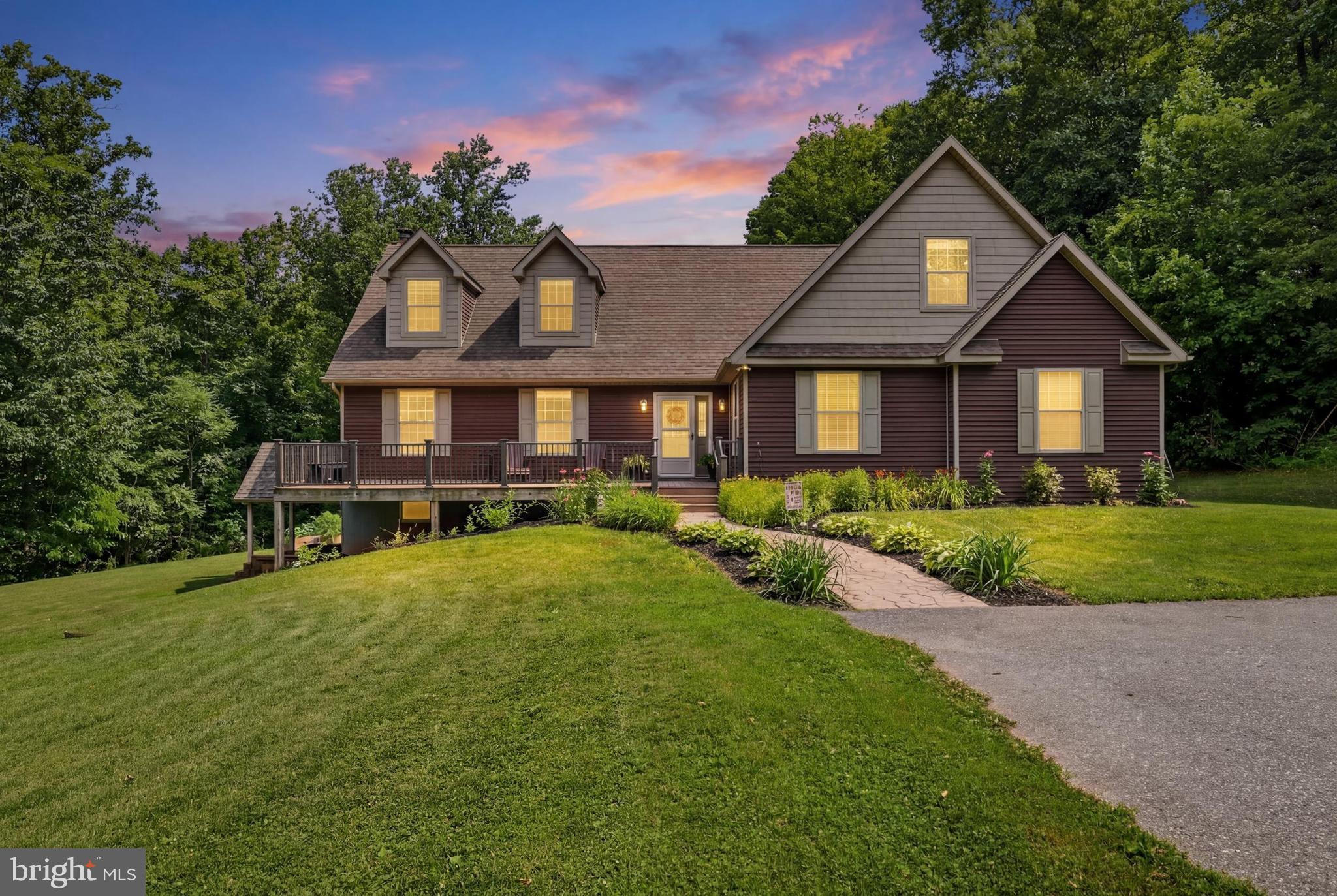 Tucked away on approximately 3.7 acres of peaceful countryside, this charming home offers the space, privacy, and versatility.  Located within the Dover Area School District, this spacious home features approximately 3,900 square feet of living space (to be verified), including 6 bedrooms and 3 bathrooms. Inside, you'll find a welcoming layout with generously sized rooms, abundant living space, and a cozy fireplace that serves as a beautiful focal point in the living room. The home is equipped with central air, geothermal heating, and a wood/coal stove in the basement, providing comfort and efficiency throughout the seasons. The outdoor setting is truly special. A maintenance-free 16' x 40' composite rear deck overlooks a stunning backdrop of mature trees and natural scenery, creating a private and serene setting. A second maintenance-free 12' x 20' composite front deck provides additional outdoor living space to enjoy the surrounding landscape. The level ground around the home offers plenty of room for gatherings, gardening, recreational activities, or simply enjoying the open space, while the wooded perimeter enhances the property's sense of privacy and seclusion. The unfinished basement is already plumbed for sewer, presenting an excellent opportunity for future expansion or customization. A detached 40' x 20' garage with three overhead doors offers ample storage, workshop space, or room for vehicles and outdoor equipment. Combining timeless charm with modern conveniences and a picturesque setting, this property offers a rare opportunity to enjoy country living.