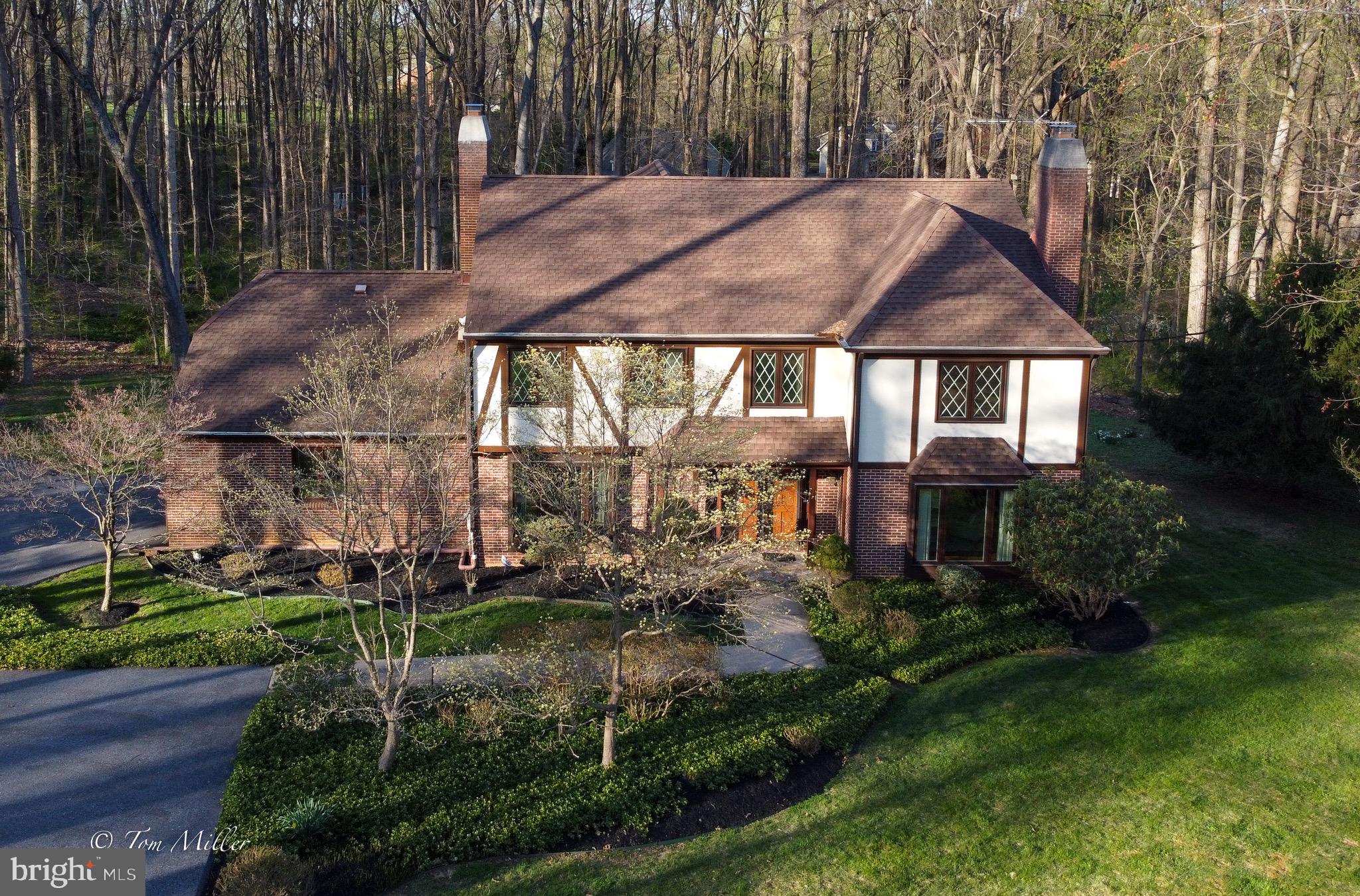Location, Location, Location!!! You will love coming home to this beautiful Tudor home in the Fallswood neighborhood conveniently located  in the Falls Road Corridor. Situated on a level partially wooded lot with plenty of privacy provides ample space for outdoor recreational activity. Walk through the front door into an open foyer with gleaming marble flooring. This home boasts a spacious floor plan with a large LR & FR both with fireplaces, a formal DR, and a huge open kitchen. The center island is extended with tons of prep and serving space. Also, there's an abundance of Corian counter space and cabinets. It'll be the hub of the home and perfect for entertaining. Upstairs are 4 large bedrooms. The primary and one other bedroom are complete with en suites.  The is also another full bath. The primary features a Jacuzzi tub and separate shower stall. A connecting room can be an additional bedroom or dressing room or an office. It's a bonus space with loads of possibilities! In the LL you will find a large Recreation room complete with wet bar and plenty of storage space. Central sound system & intercoms on all 3 levels. Heating & cooling systems installed in 2001 & 2019. All appliances 2001. Roof 2001. Well pump 2020. Water tank 2021. Central alarm. Don't miss this lovely home!! Make your appointment today!!