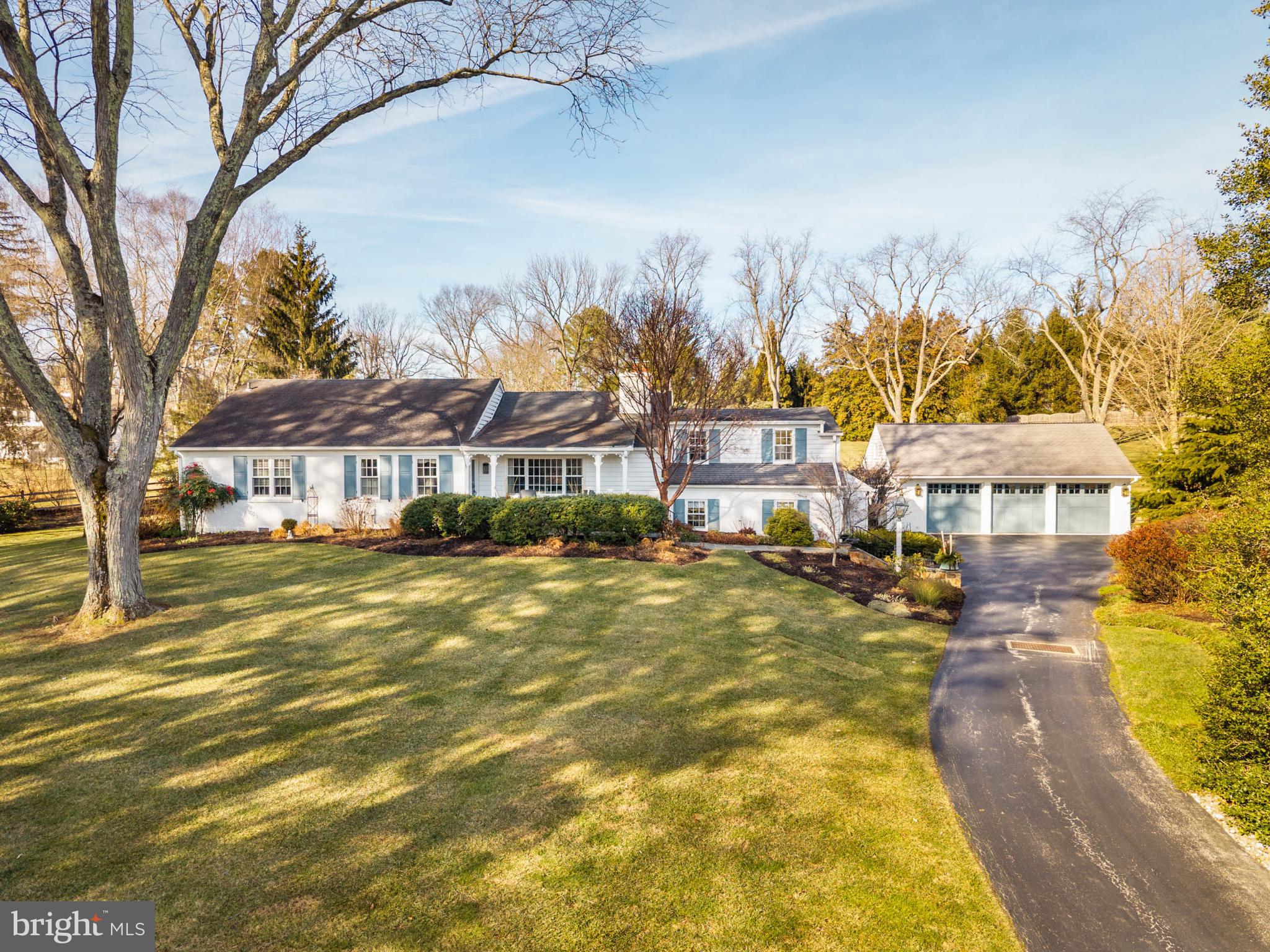 Nestled in the prestigious Radnor Hunt community, this exquisitely maintained home offers a harmonious blend of luxury and comfort resting privately on 2.1 glorious acres. From the cozy front porch to the back patio and sunroom, pride of ownership is evident throughout all the details of this warm and inviting property. A major renovation with multiple additions in 2001 and subsequent beautiful touches added in 2024 showcase tasteful finishes and thoughtful design throughout. Discover an inviting interior adorned with rich hardwood floors, stylish wainscoting, detailed woodwork, custom doors, abundant natural light and expansive views of the surrounding grounds. The spacious layout features the addition of a gorgeous main floor primary suite with custom woodwork, double sinks, a claw foot tub, spacious shower and walk-in closets. Nudge open the French doors and retreat to a private oasis surrounded by beautiful greenery, custom hardscaping and a sunken hot tub. Adjoining the suite is a tastefully designed office space with natural light and built-in cabinetry. The spectacular views continue through the dining room, kitchen and enclosed sun room where morning coffee and evening sunsets can be savored in a tranquil and serene setting. The living room and family room each showcase wood-burning fireplaces that create a warm ambiance to unwind in the comfort of your living spaces. A fully-finished daylight basement complete with a walkout level offers additional living space and versatility. This level includes a large game room and bar, a second kitchen to help with holiday entertaining and a tastefully designed laundry laundry room. A lit breezeway connects the home with a detached 3-car garage that includes a lovely heated room used as a potting shed. This home is also equipped with one of the largest whole house generators you'll ever see! 1 Treble Lane is a beautifully maintained home and property that combines the charm and tranquility of Willistown living with easy access to the surrounding towns of Malvern, Paoli, Berwyn and Newtown Square.