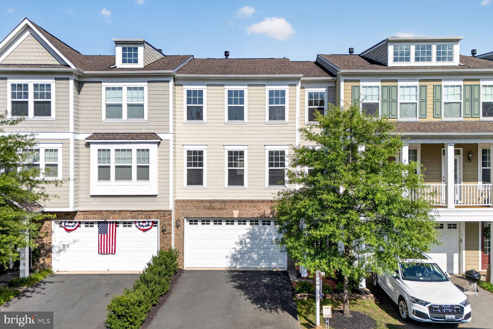 Beautifully maintained brick-front townhome offering 3 bedrooms, 2 full baths, 2 half baths, and three finished levels in the highly desirable Oakton East community of Oakton. This light-filled home features hardwood flooring throughout the main and upper levels, fresh paint throughout, 9-foot ceilings on the main level, an open floor plan, and numerous updates, all within the sought-after Oakton High School pyramid and just minutes to I-66, Vienna Metro, shopping, and dining.

A welcoming two-story foyer with ceramic tile flooring, hardwood staircase, and brushed nickel chandelier opens to the spacious main level. The living room features hardwood floors, recessed lighting, two-piece crown molding, blinds, and a cozy gas fireplace with a slate surround and wood mantel. The adjoining gourmet kitchen offers granite countertops, 42-inch maple cabinetry with crown molding, stainless steel appliances including a KitchenAid five-burner gas cooktop, built-in microwave, Whirlpool double wall ovens (2025), GE French door refrigerator, KitchenAid dishwasher, subway tile backsplash, oversized center island with breakfast bar, recessed and pendant lighting, walk-in pantry, and double undermount sink. The spacious dining area is accented with crown molding, chair rail, shadowbox molding, and a sliding glass door leading to the updated Trex deck (2021) overlooking the common area—perfect for entertaining or relaxing outdoors. Two coat closets and a convenient powder room complete the main level.

The upper level features hardwood flooring throughout, fresh paint, recessed hallway lighting, and an upper-level laundry room with washer and dryer (2024) and built-in shelving. The spacious primary suite offers a ceiling fan, two walk-in closets with custom organizers, and a beautifully appointed en-suite bath with ceramic tile flooring, dual granite-topped vanities, private water closet, and an oversized frameless glass shower with custom tile surround, rain shower head, additional handheld shower, and built-in bench. Two additional bedrooms feature ceiling fans, cellular blinds, and generous closet space and share an updated hall bath with dual-sink vanity, ceramic tile flooring, and tub with tile surround.

The finished walkout lower level offers a spacious recreation room with 9-foot ceilings, recessed lighting, blinds, sliding glass door to the backyard, a convenient powder room, ceramic tile mudroom with coat closet, and direct access to the oversized two-car garage with additional storage space.

Recent improvements include Whirlpool wall ovens (2025), washer and dryer (2024), Trex deck with 50-year material warranty (2021), GE refrigerator (2019), hardwood flooring on the upper level (2018), and frameless primary shower door (2018). Ideally located within the highly rated Oakton Elementary, Thoreau Middle, and Oakton High School pyramid, this exceptional home offers easy access to I-66, Route 123, Vienna Metro, parks, shopping, restaurants, and all that Northern Virginia has to offer.