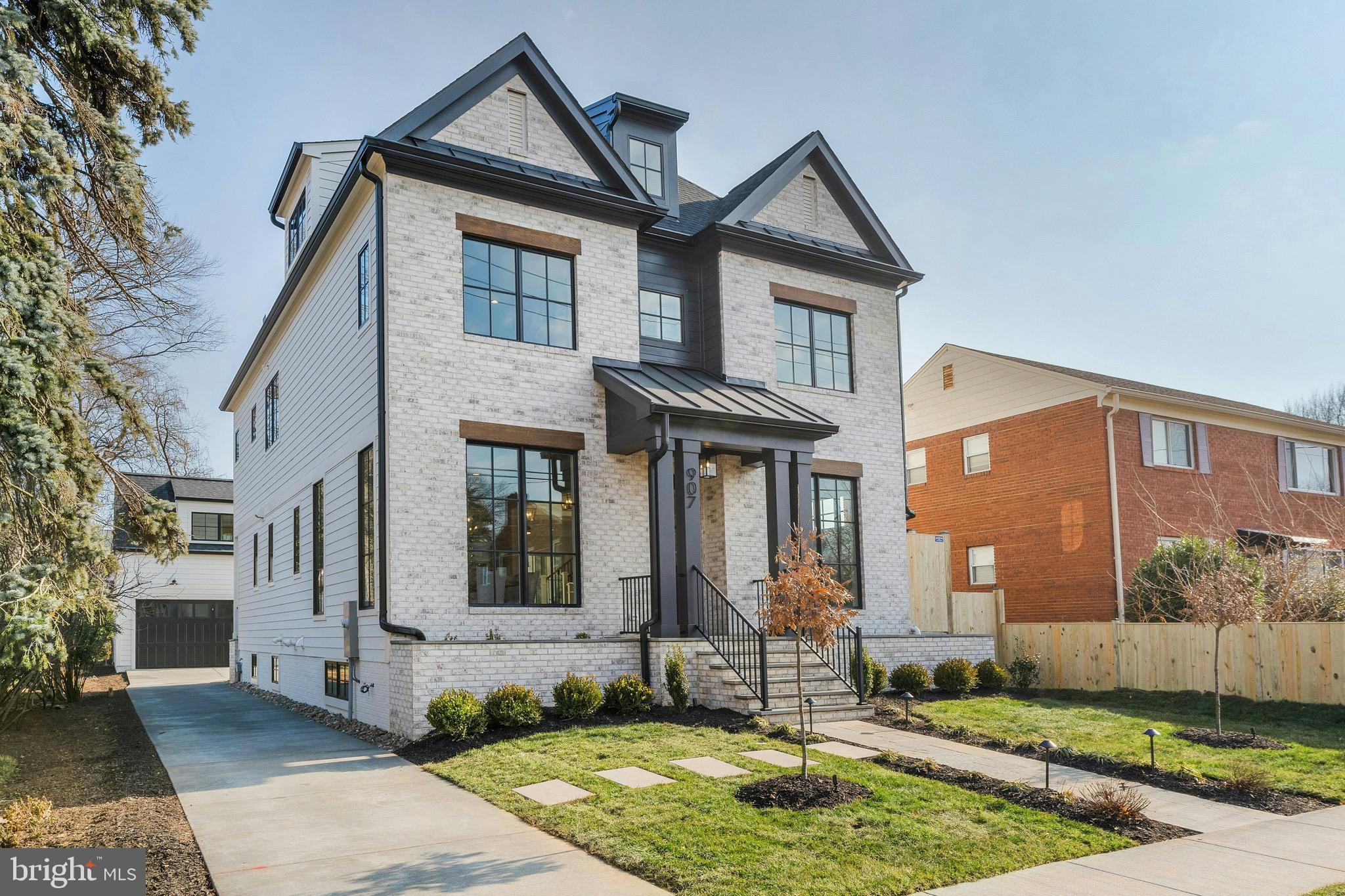 Modern Luxury Meets Timeless Craftsmanship in the Heart of Clarendon
📍 Clarendon | 🛏 6 Bedrooms + Studio bedroom | 🛁 6.5 Baths | 📐 Approx. 6,025 Sq Ft | 🚗 Detached 2-Car Garage w/ ADU |  New Construction

Welcome to your dream home nestled on a picturesque  lot in the heart of Clarendon, one of Arlington's most sought-after neighborhoods. This brand-new construction by MR Custom Homes blends classic elegance with contemporary design across four beautifully finished levels—plus a separate studio suite above the garage—offering the perfect balance of space, sophistication, and smart functionality.

Exceptional Exterior Details:
Crafted with James Hardie smooth siding, a brick front veneer, and Tamko architectural shingles, the home is as durable as it is stunning. Step up to the flagstone front porch, admire the professionally landscaped grounds, and enjoy peaceful evenings on the rear screened porch featuring ceiling heaters, speakers, and a gas line ready for your grill. The two-car detached garage includes a fully finished studio/office ADU with a rough-in for a 240V EV charger—ideal for guests, rental income, or remote work.

Light-Filled Living Spaces:
Inside, soaring 10' ceilings on the main level and 9' ceilings upstairs create an airy, open feel. The gourmet kitchen is a chef’s delight, with custom inset maple cabinetry, 2.5" Quartz countertops, and top-of-the-line appliances including a 48” Wolf gas range and Sub-Zero fridge. Entertain in style with a butler’s pantry, large center island, and breakfast nook that flows seamlessly into the family room with a 48” linear gas fireplace and ceiling beams.

Thoughtful Floor Plan:
With 6 bedrooms, 5 full baths in the main house, and a powder room, this home was designed with flexibility and comfort in mind. The first floor features a private library with built-ins, formal dining, and a mudroom with custom cubbies. Upstairs, the luxurious primary suite includes a tray ceiling, spa-like bathroom with heated floors, soaking tub, frameless glass shower, and a massive walk-in closet. The second floor also hosts a laundry room with a sink and three more bedrooms—including a Jack & Jill layout and one en-suite.

The 3rd-floor loft offers additional living space with a wet bar, bedroom, and full bath—perfect for multi-generational living, guests, or play space.

Lower Level Retreat:
The expansive finished basement includes a rec room with a wet bar, exercise room, in-law suite, and a finished storage room. The flooring throughout is both beautiful and practical: White Oak hardwoods, luxury vinyl tile, rubber gym flooring, and premium carpeting.

The ADU above the garage has a private entrance,  full bath, kitchenette, separate heating/cooling & lots of closet storage.

High-End Systems & Smart Features:
Built with energy efficiency in mind, the home includes Andersen 400 Series windows, upgraded insulation (R-49 attic, R-15 walls), a ProLine XE 75-gallon water heater, and zoned Carrier HVAC with Aprilaire air filtration and humidifier. Tech-savvy buyers will appreciate CAT6/RG6 wiring, Ecobee doorbell camera, built-in ceiling speakers in key rooms, and 400-amp electric service.

Built by the Trusted 3rd Generation Builder, MR Custom Homes, this property comes with a full 1-year warranty, plus structured pre-settlement walkthroughs and service appointments for your peace of mind.

📞 Don't miss this rare opportunity to own a true showpiece in Clarendon.  Home is completed and ready for its new owner.