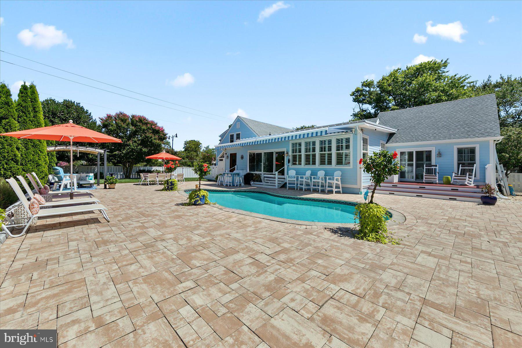 Welcome to your dream beach home, fully renovated and perfectly situated on an oversized double lot with a private in-ground pool, just two blocks from the sand and a short stroll to downtown Bethany. This 6-bedroom, 4-bath coastal cottage beautifully blends timeless architecture with modern luxury. Step inside to discover rich hardwood flooring throughout, a bright open floorplan, and thoughtful upgrades like a double-sided fireplace, granite countertops, tiled backsplash, wainscoting, and exposed wood beam ceilings. Designed with comfort and style in mind, the home features three en-suite bedrooms—two conveniently located on the main level—and a spacious additional family room for flexible living. Relax on the charming screened porch or host unforgettable gatherings on the expansive Travertine patio surrounding the pool—designed to stay cool under the summer sun. Whether you’re soaking in the sun poolside or enjoying ocean breezes from your private oasis, this home offers the ultimate coastal lifestyle. Sold fully furnished and move-in ready, don’t miss your opportunity to enjoy the best of Bethany Beach living, all year long.