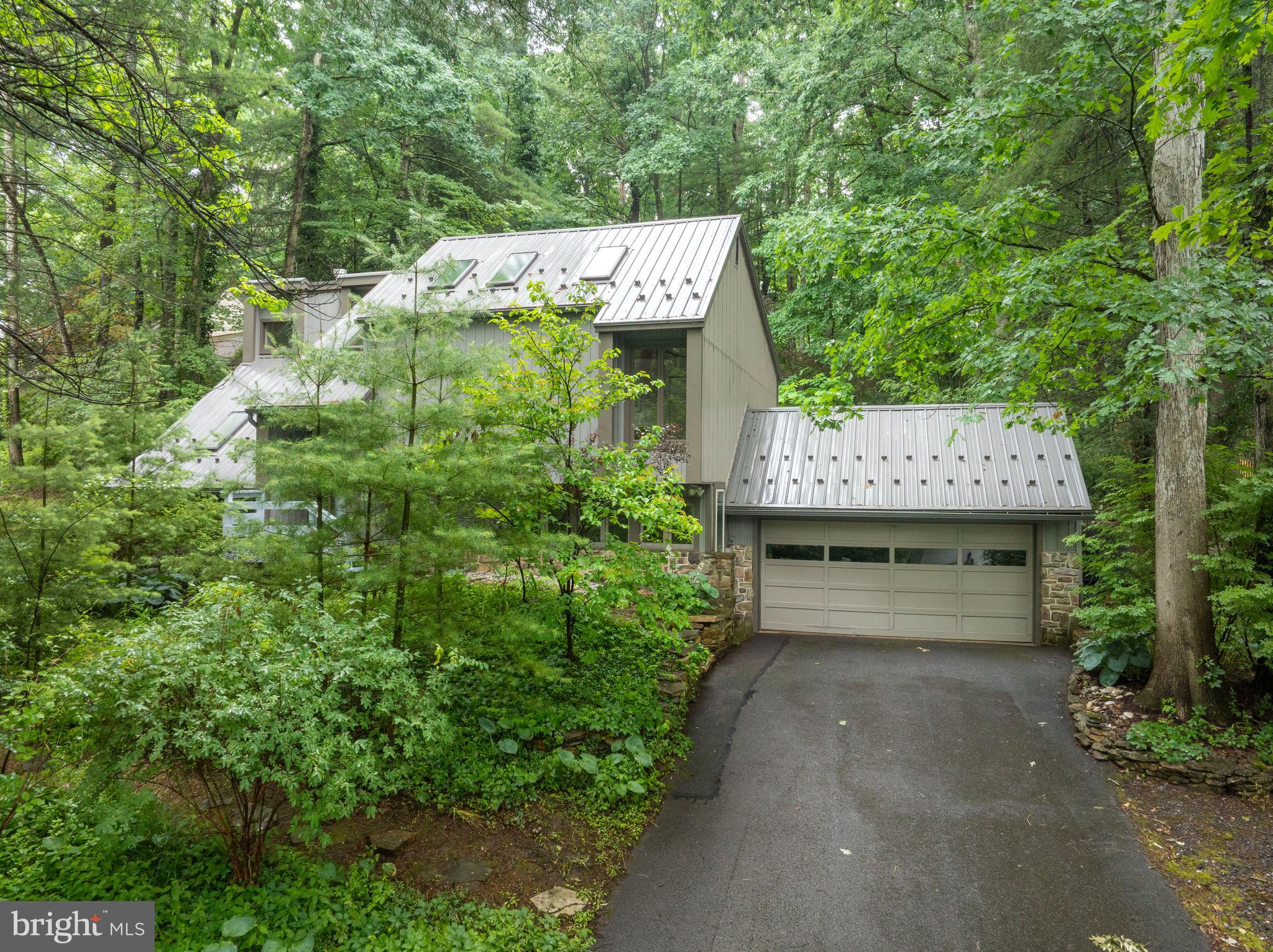 OPEN HOUSE - Thursday, July 2nd, 4:00 - 5:30 PM
Tucked away, yet close to everything at 17 Coventry Lane! Welcome to this architecturally stunning contemporary home with mountain modern flair, with 3 beds, 2.5 baths and 2,500 sqft. Bask in awe at the soaring cathedral ceilings, walls of windows and thoughtfully placed skylights for maximum sunlight and nature viewing. The expansive kitchen features recessed lighting, triple sink, wall oven, SS appliances, and two islands for prep space. Enjoy bar seating off the kitchen and an additional dining room for gatherings. A large living room and half bath complete the main floor. Thoughtful storage throughout the home includes two separate attic spaces and a large under‑stair closet. You'll love the primary bedroom with a dramatic, wood-clad vaulted ceiling, two extended skylights, walk-in closet and beautiful ensuite bath with tiled shower and skylight. Two additional bedrooms with hardwood floors share a Jack and Jill bath upstairs. Entertain or relax in the cozy sunroom/living room with gas fireplace or the enclosed 3-season porch overlooking the backyard. The back deck, a private setting surrounded by woods and terraced stone walls, is the perfect spot to unwind, gather with friends or simply take in the nature around you! Other notable highlights: newer metal roof (2019), new siding and insulation, central air, 2-car attached garage, and beautiful masonry. This home is truly unique and the setting provides a feeling of peace and seclusion, while being just minutes away from State College venues, downtown and Penn State. Schedule your showing today!